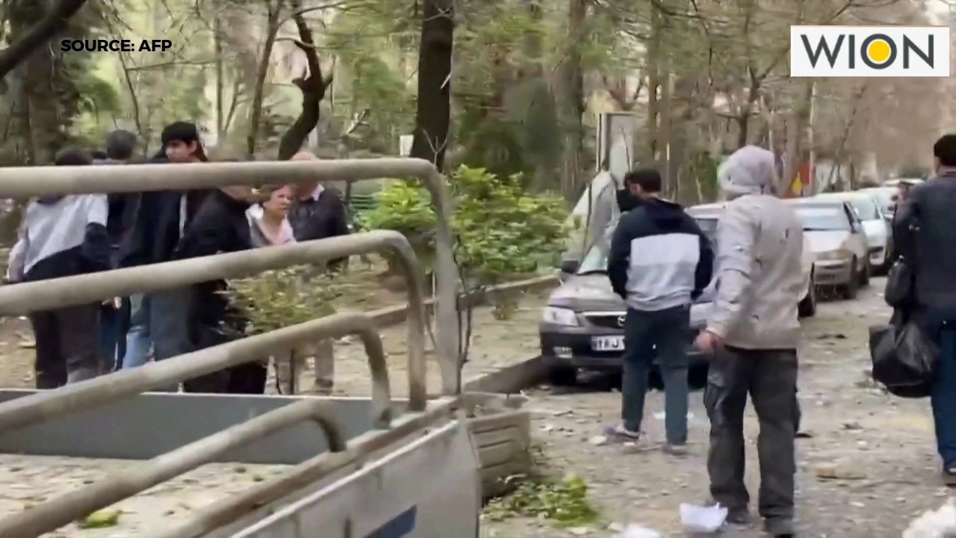 Residents, some visibly injured, leave their homes with belongings in ...