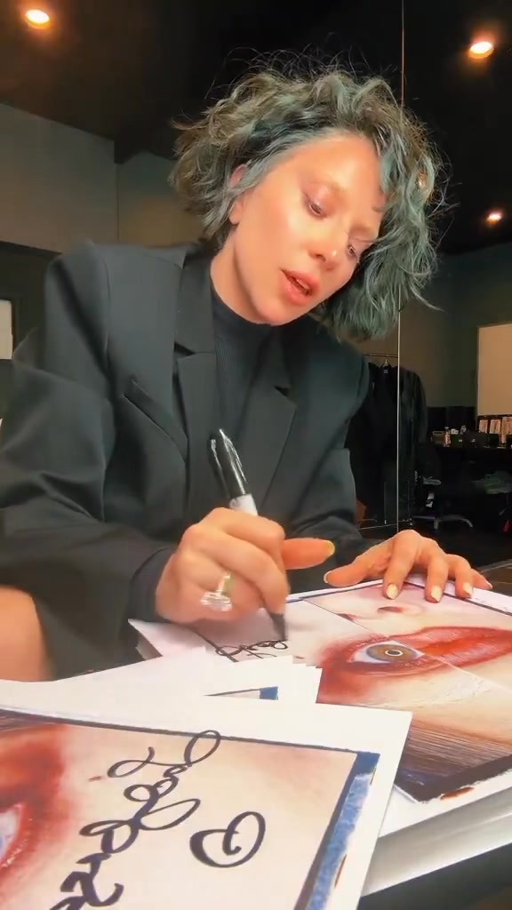 Lady Gaga shares a TikTok signing copies of MAYHEM: 
