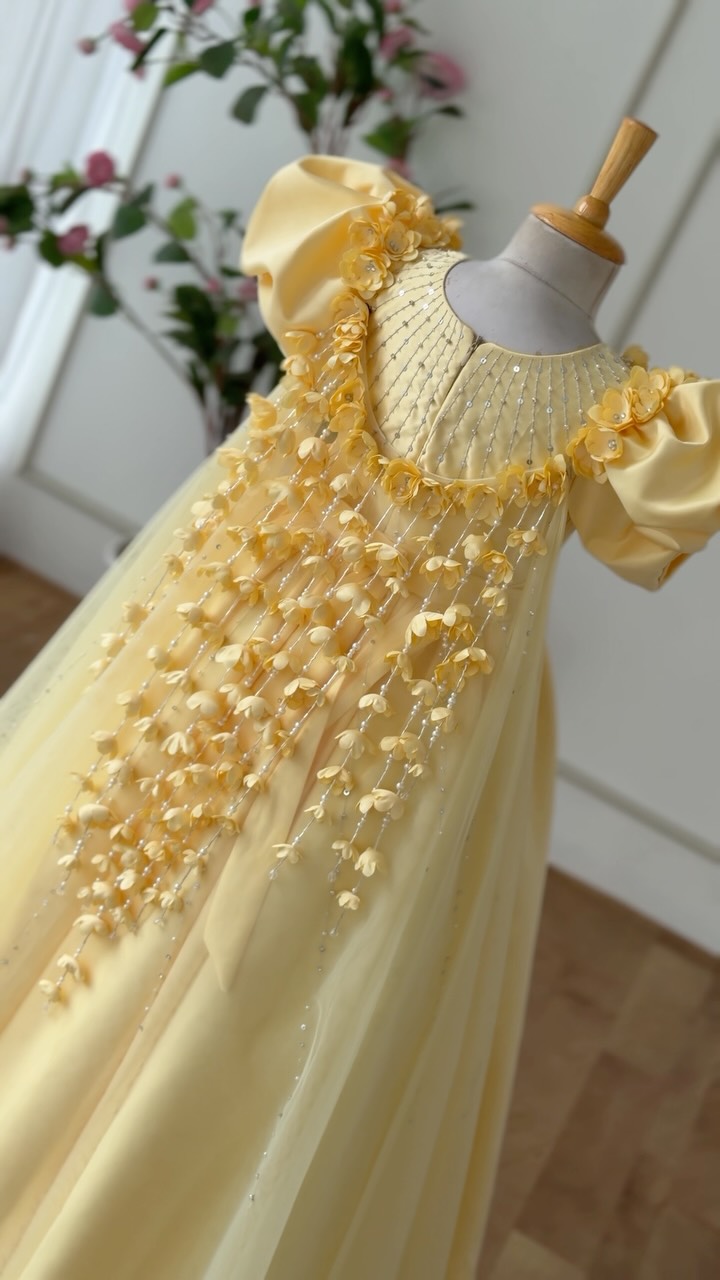 flowy princess dress ✨ A dreamy pastel-yellow gown crafted with delicate floral detailing. The features a beautifully gathered, silhouette that creates an elegant princess-like look. The neckline is Off Shoulder Ruffle wedding gowns