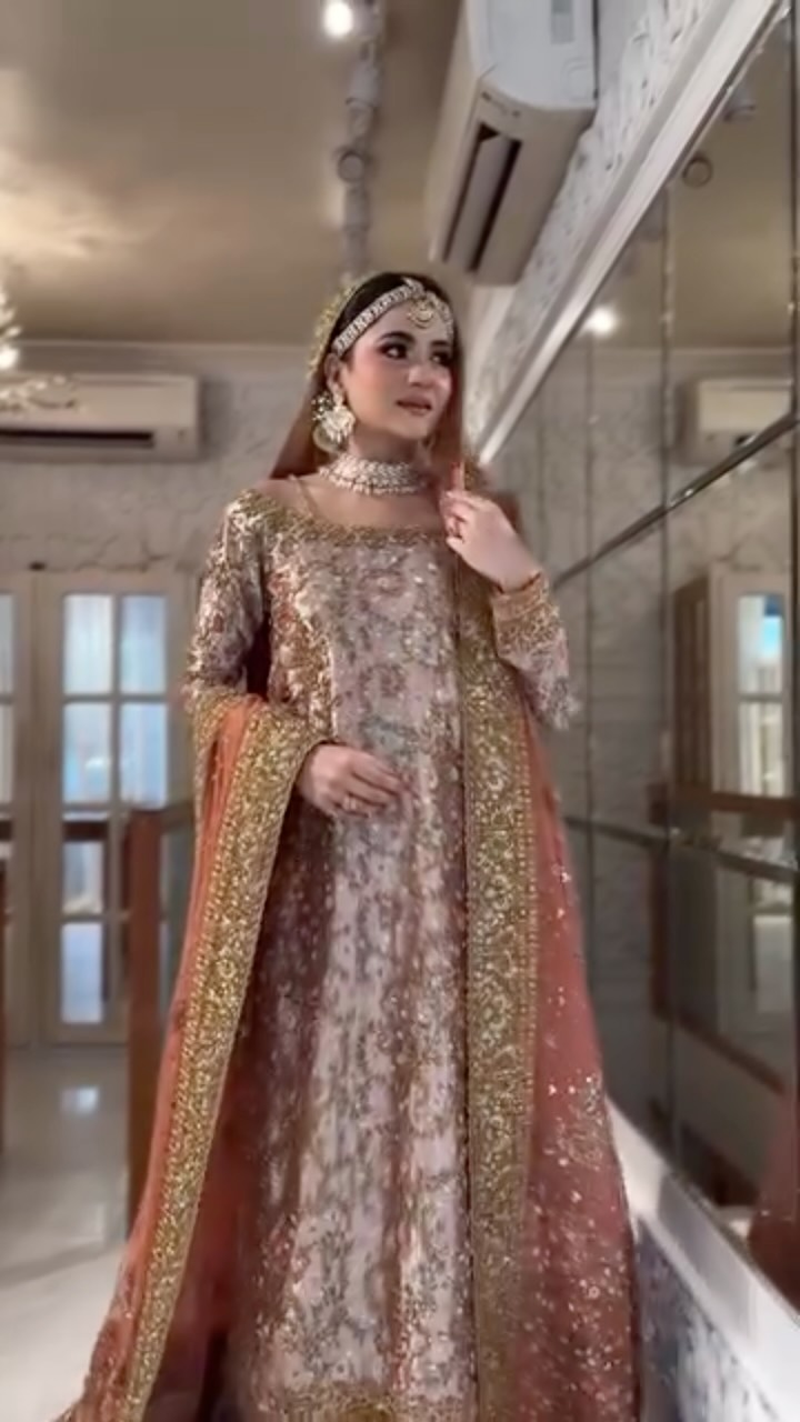 A moment of quiet luxury wrapped in gold and rust tones 🤍, This look is all about timeless elegance — intricate embroidery, soft shimmer, and that statement dupatta that carries the whole vibe 