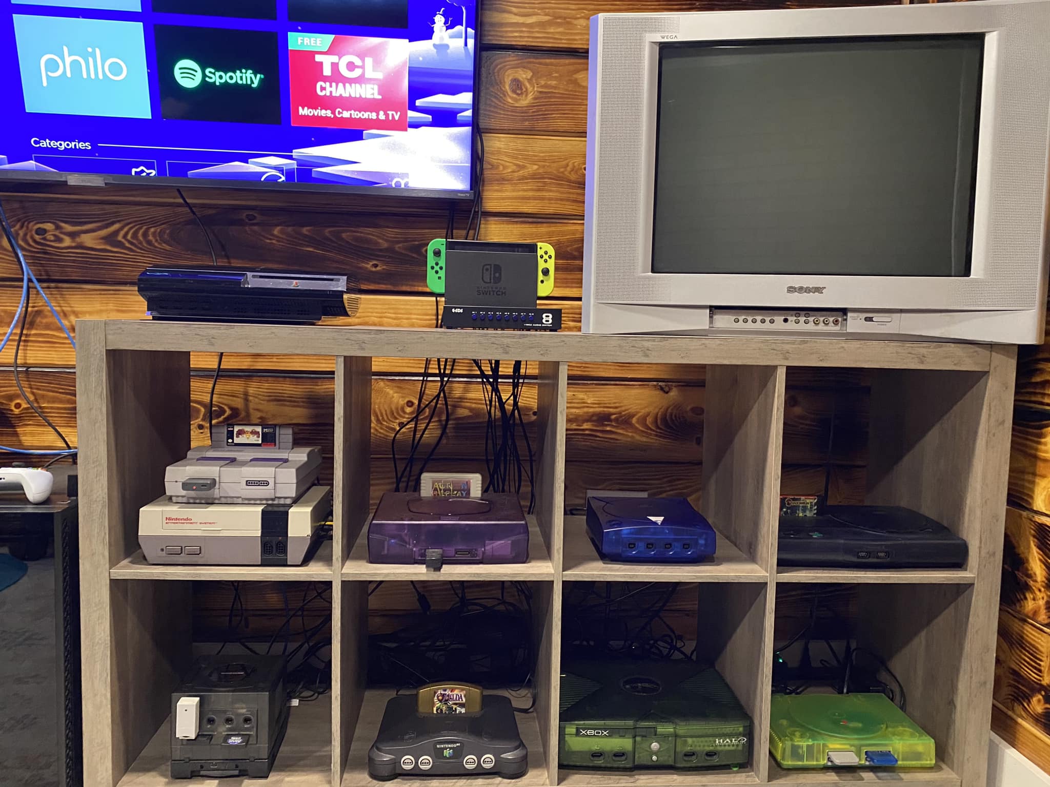 80s home entertainment setup with multiple consoles