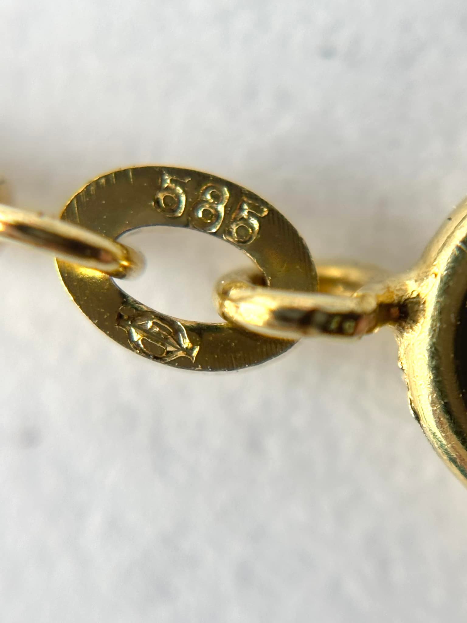 What does the stamp next to 585 mean in 14k gold?