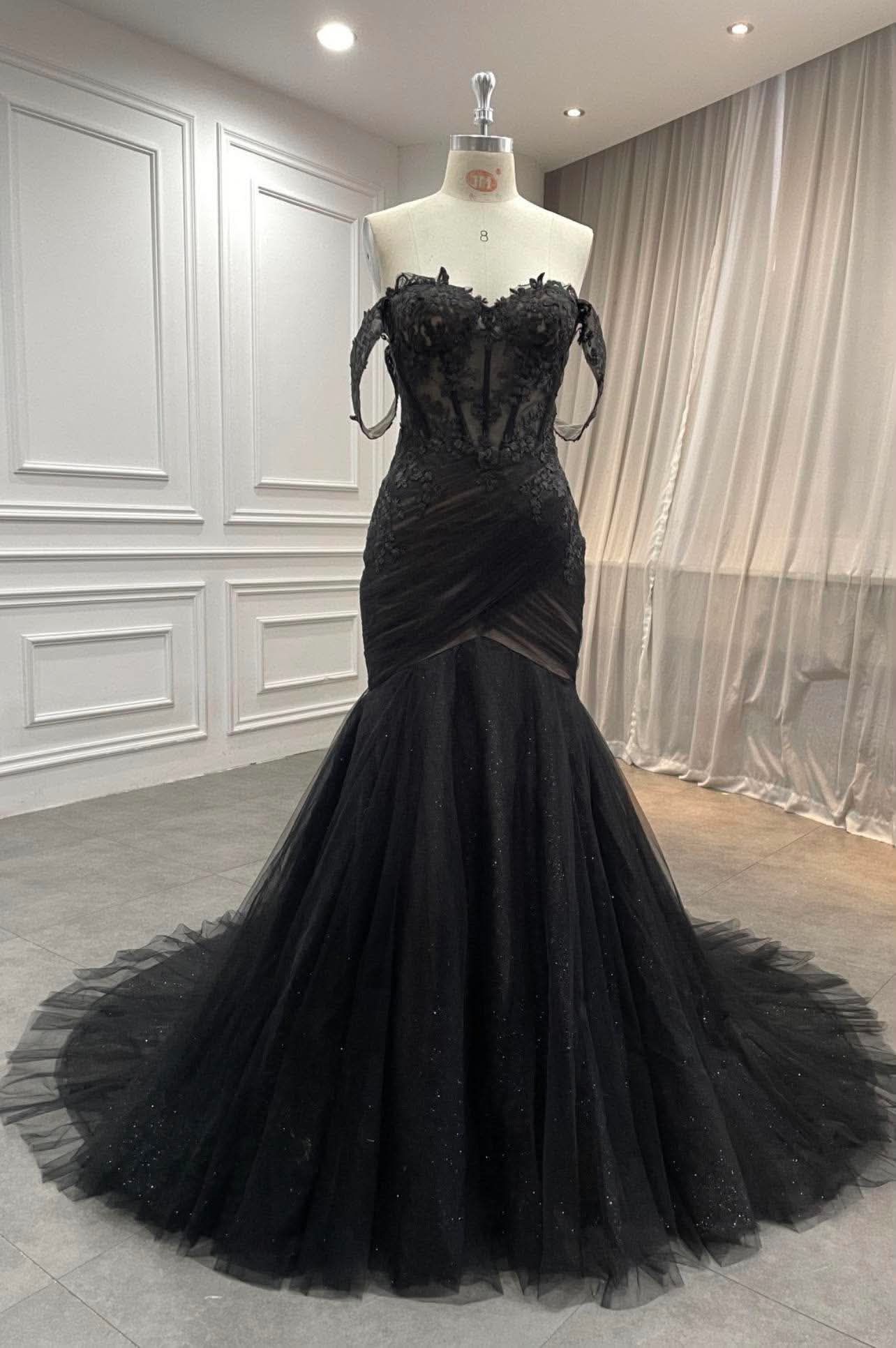 Stunning black off-the-shoulder mermaid wedding dress with lace and tulle details