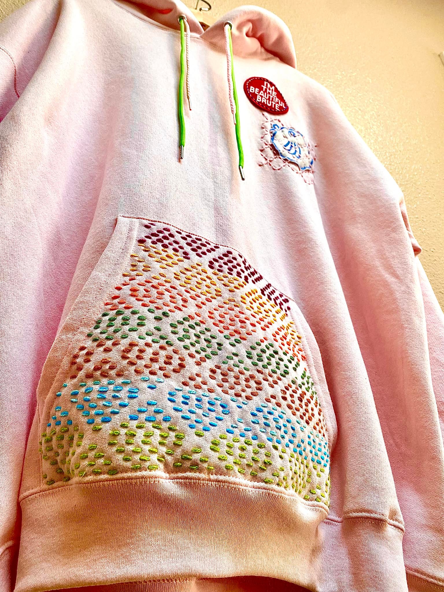 Pink hoodie with sashiko pocket detail