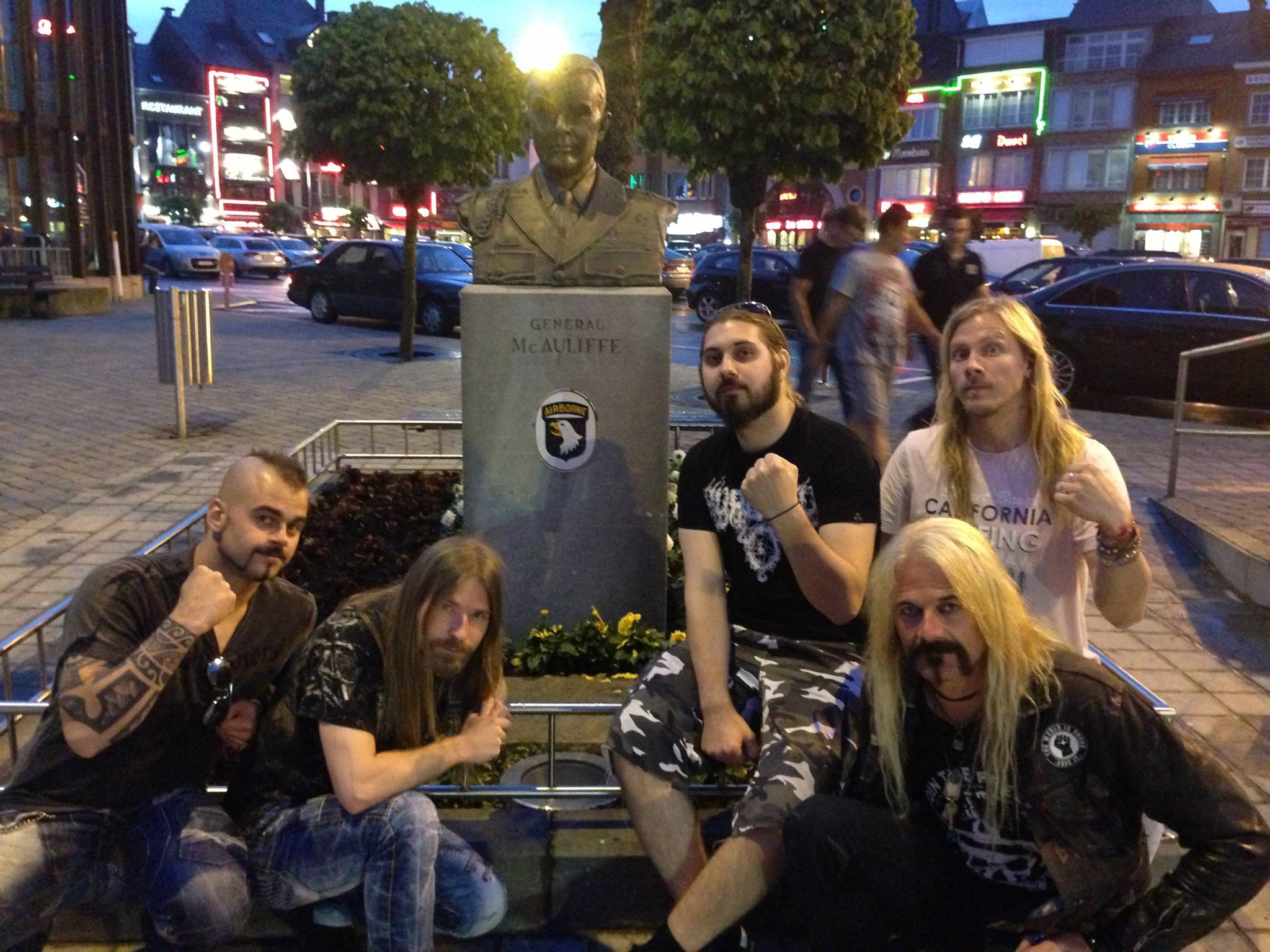 Ruffage - Sabaton posing with a memorial dedicated to Gen....