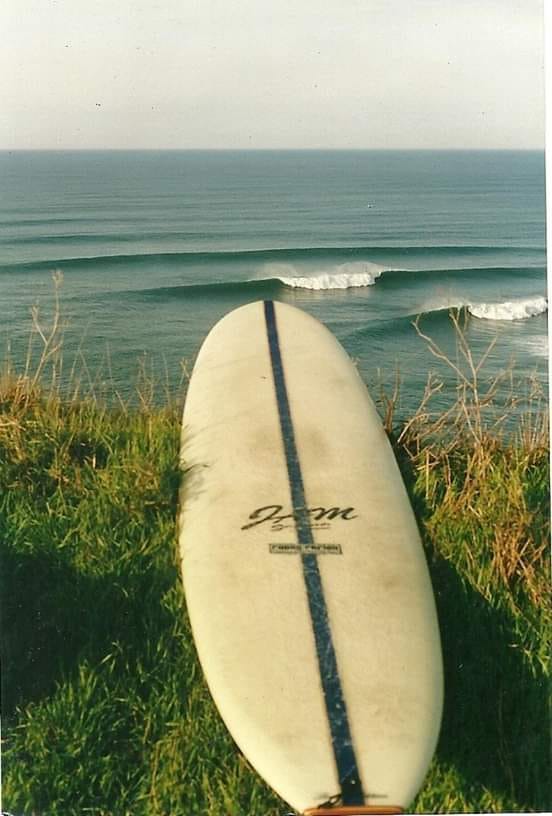 Riding a classic 8-foot surfboard shaped by Randy Rarick