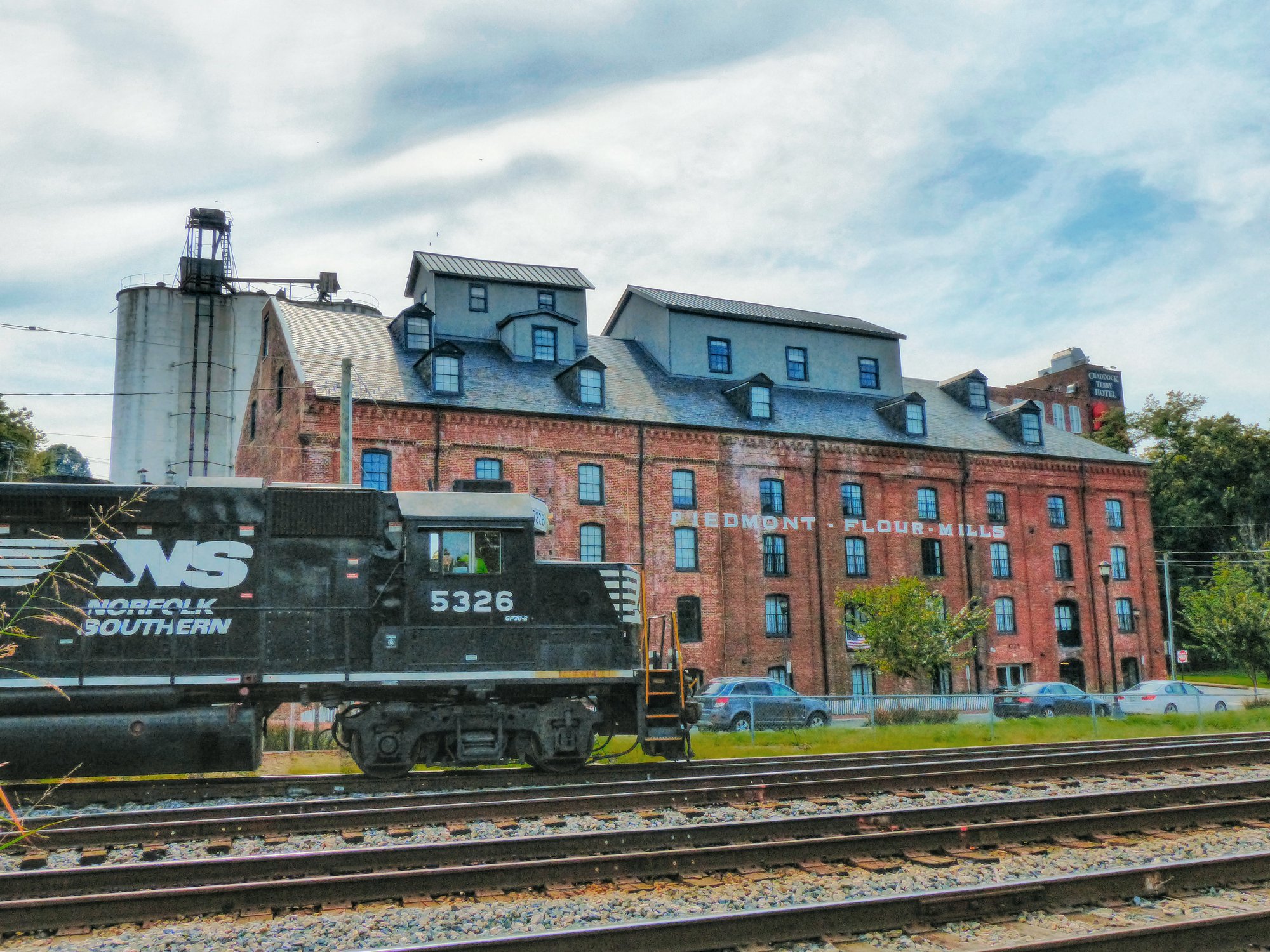 Norfolk Southern train passes Piedmont Flour Mill Lofts in 