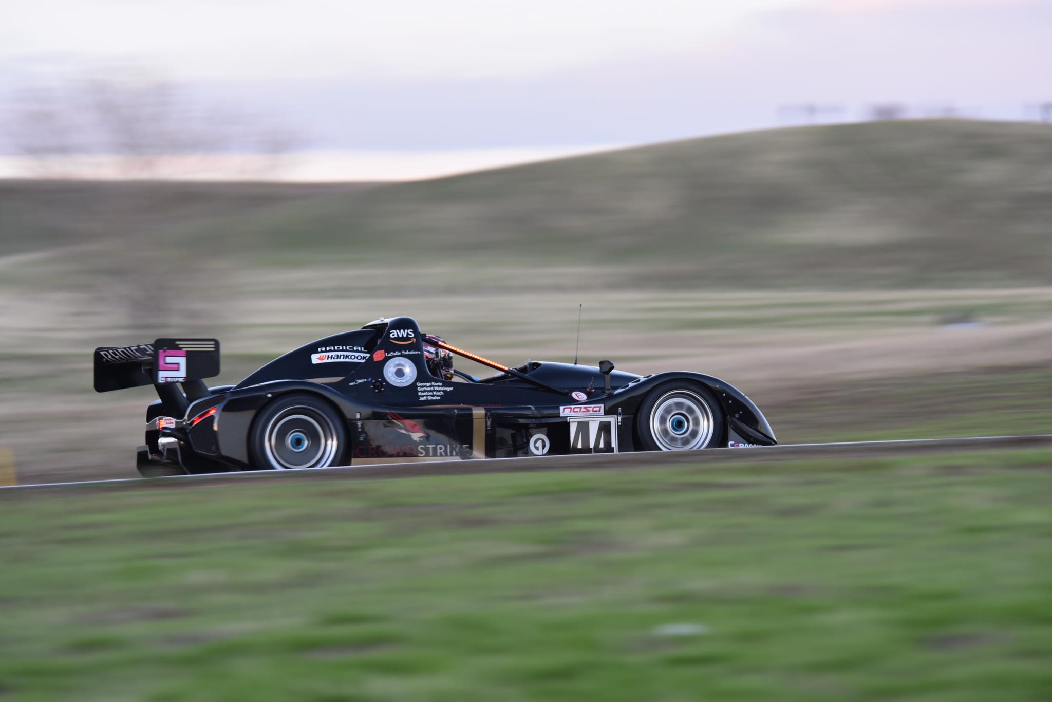 The leader blurring the trackside. - Sports Racer Network