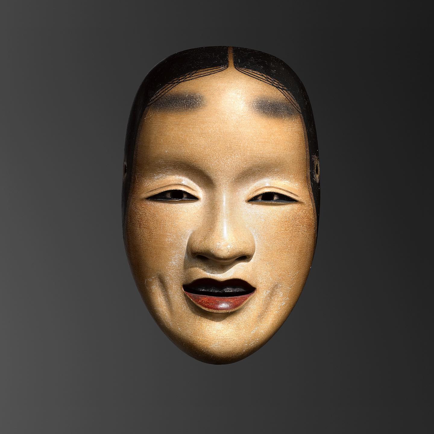 Depicting the three stages of carving a Noh mask, these hinoki