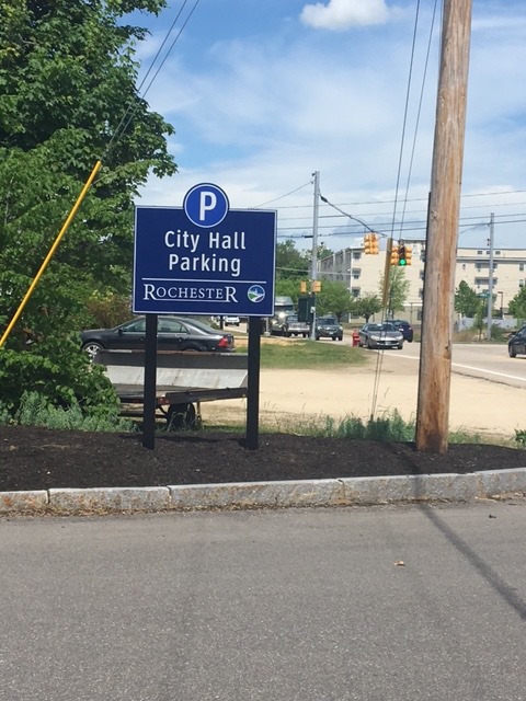 Wayfinding signs are being installed. The three large parking lot signs ...