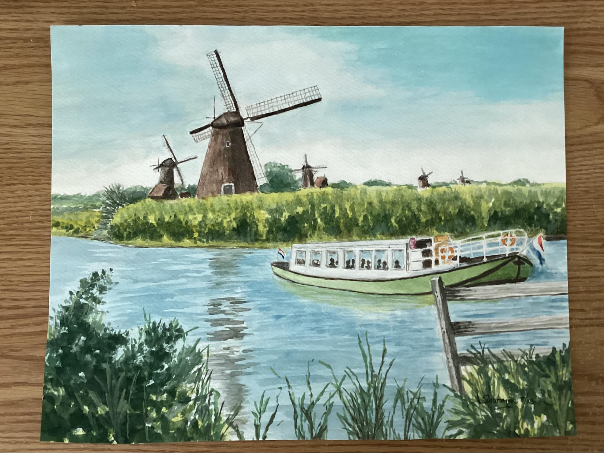 Classic Dutch windmill scene by a calm canal