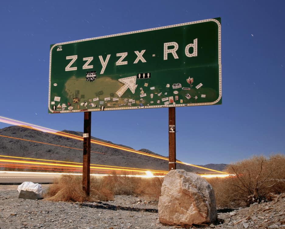 What is the pronunciation and destination of the Zzyzx road sign?