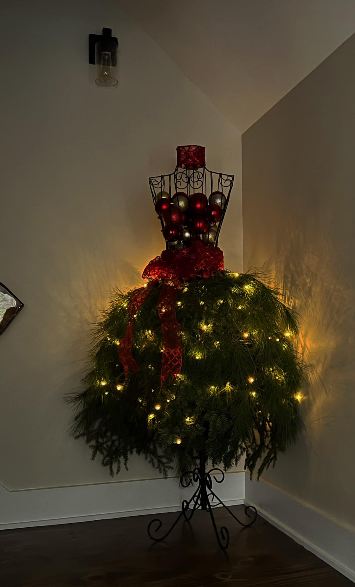 INFO: I purchased the wire mannequin from Amazon. This year I harvested branches from three variations of pine trees on my property to make her skirt. This is my first year in
