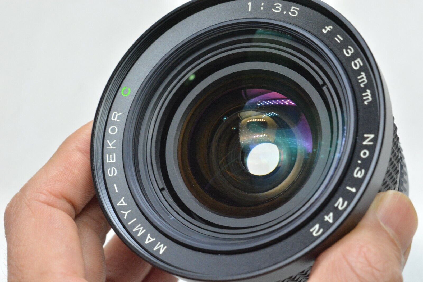 Two Mamiya 90mm f/3.8 Sekor lenses. One's well-loved, the other's