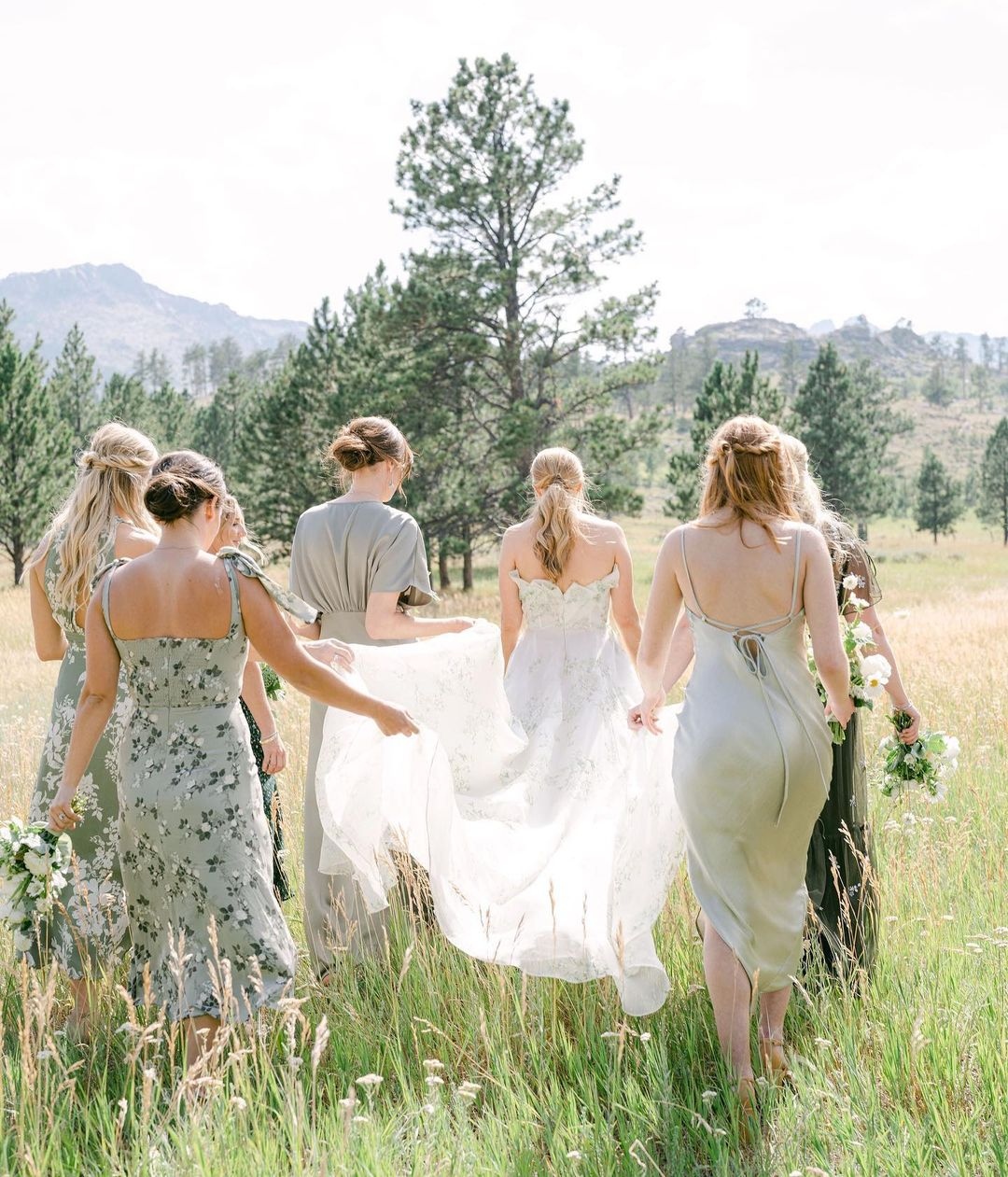 garden style bridesmaid dresses gowns in shades of green is our onset of Fall love language. 💚 Each of these bridesmaids are exceptionally styled, and make a stunning group along side the brides custom @ Shorts Adolfo 6 Drawer Dresser Rental Duration:4 Days and a flowing mermaid