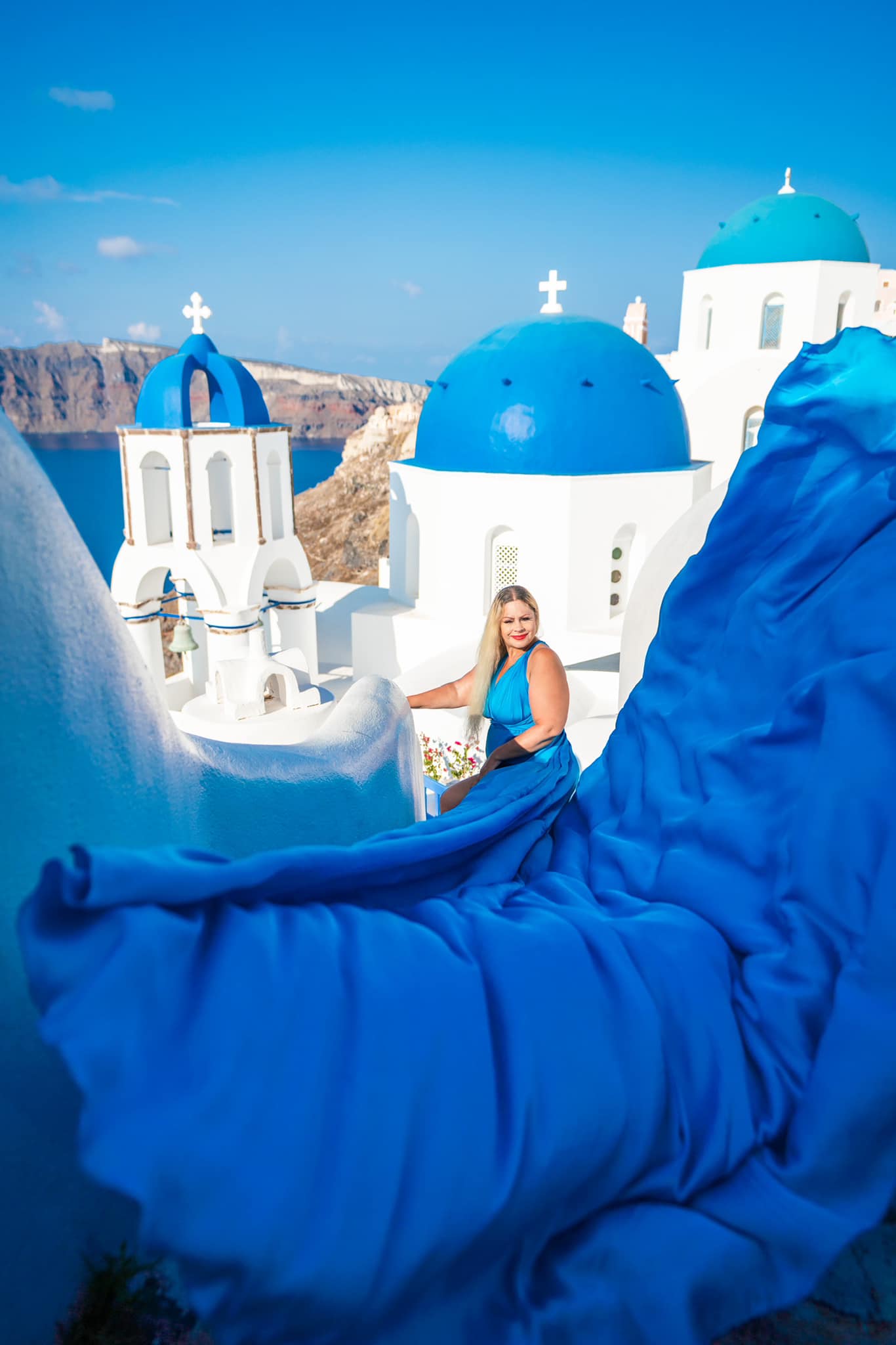 flowy dress photoshoot in greece Santorini sunsets and flying experience santorini greece photoshoot