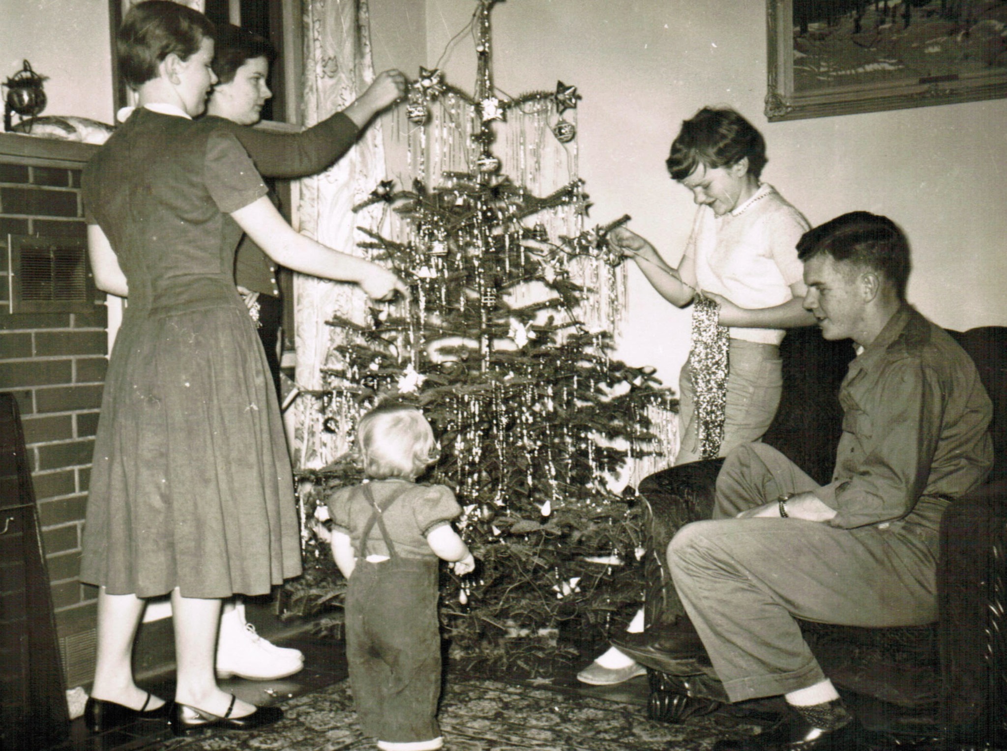 Ozzie, Harriet, Ricky & David Nelson in front of the Christmas