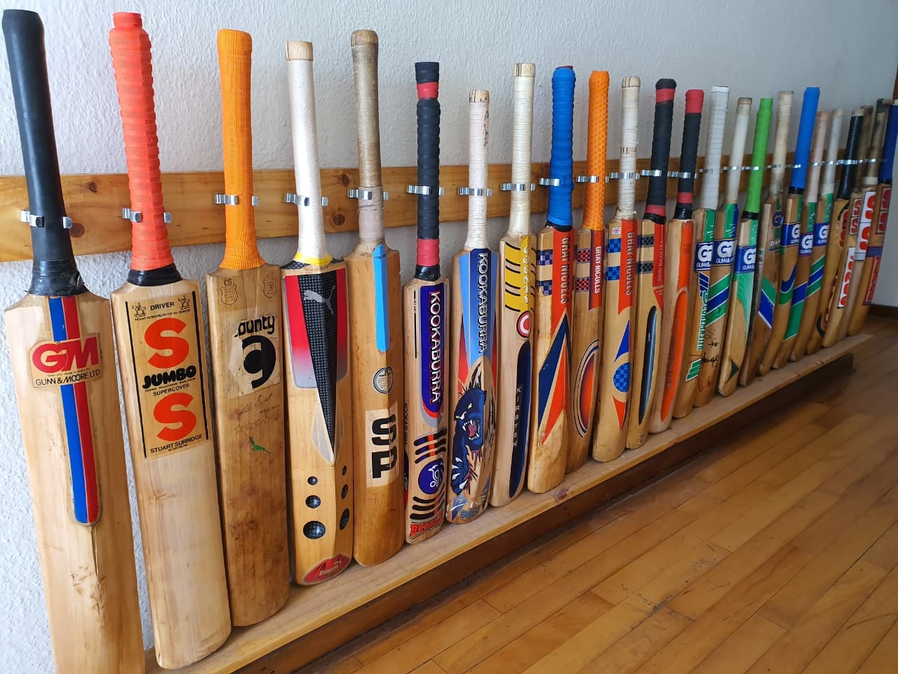 Old cricket bats resting in a corner, holding memories of 