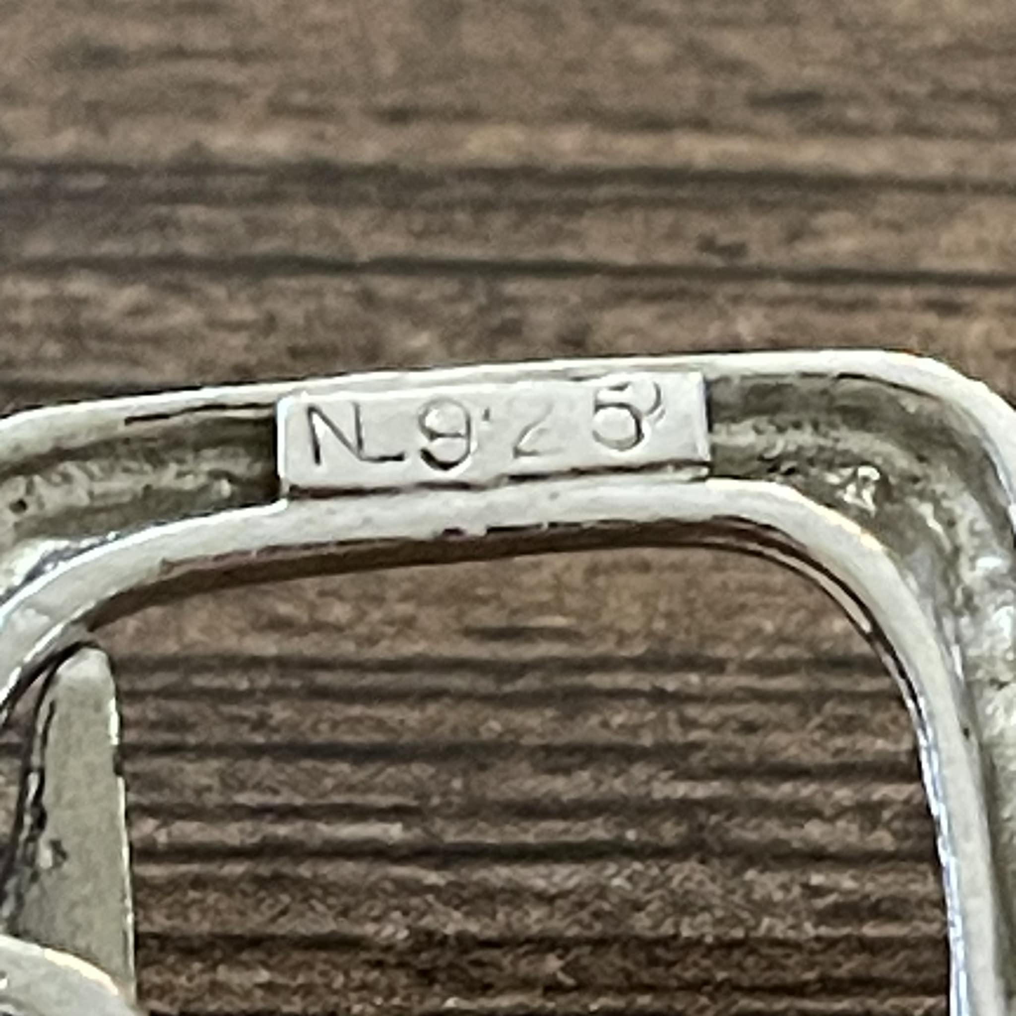 What is the meaning of NL 925 on a sterling silver bracelet?