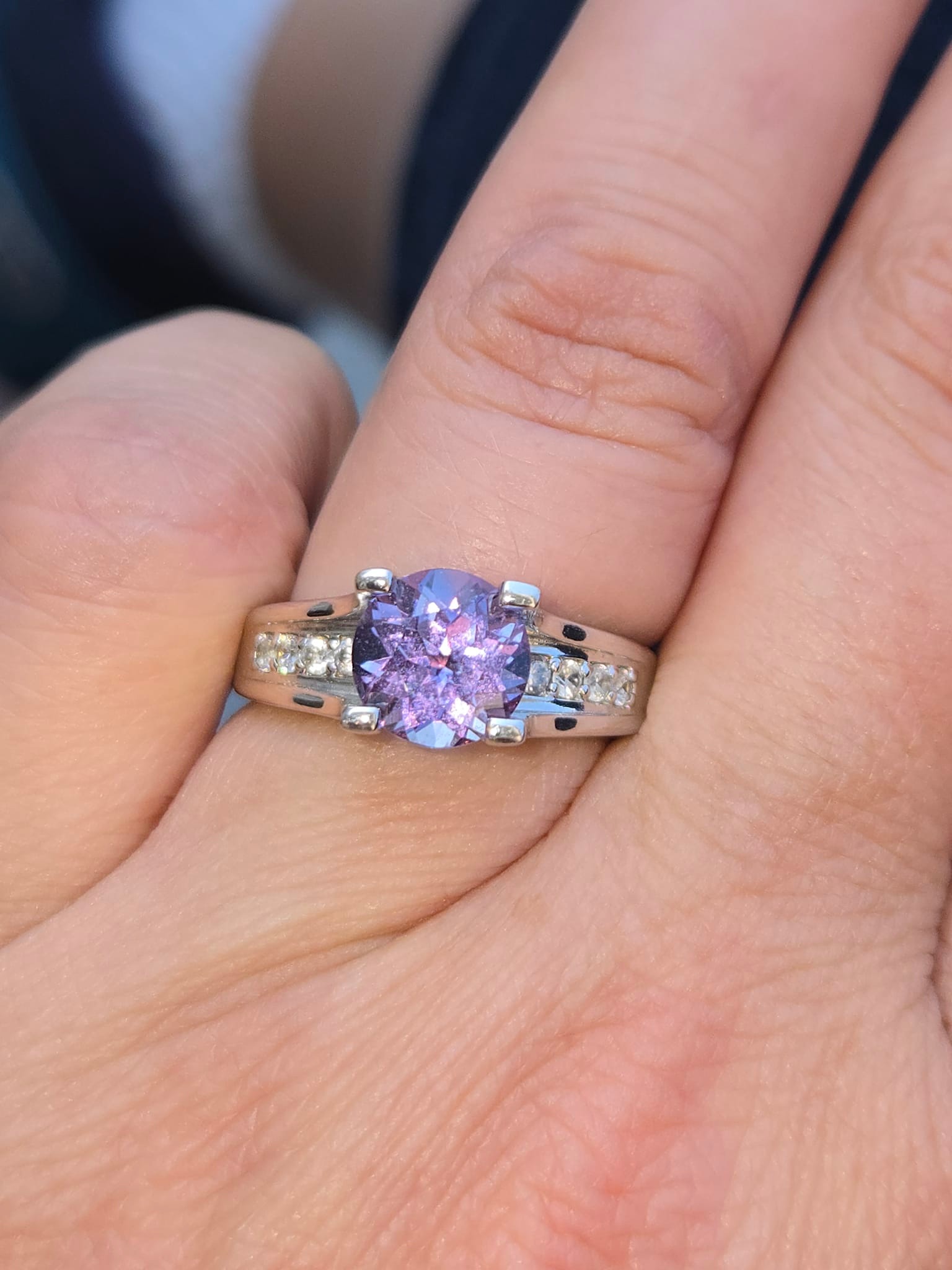 What type of stone appears blue to the eye but purple through a 