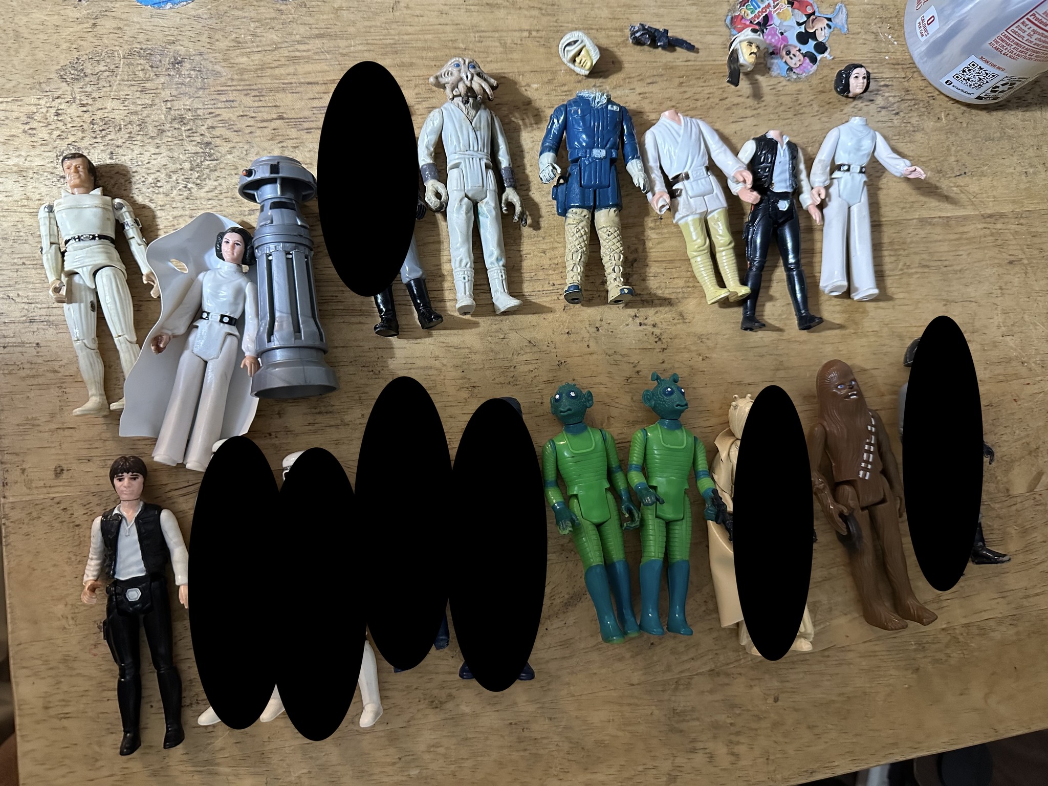Figures for sale, some with damage
