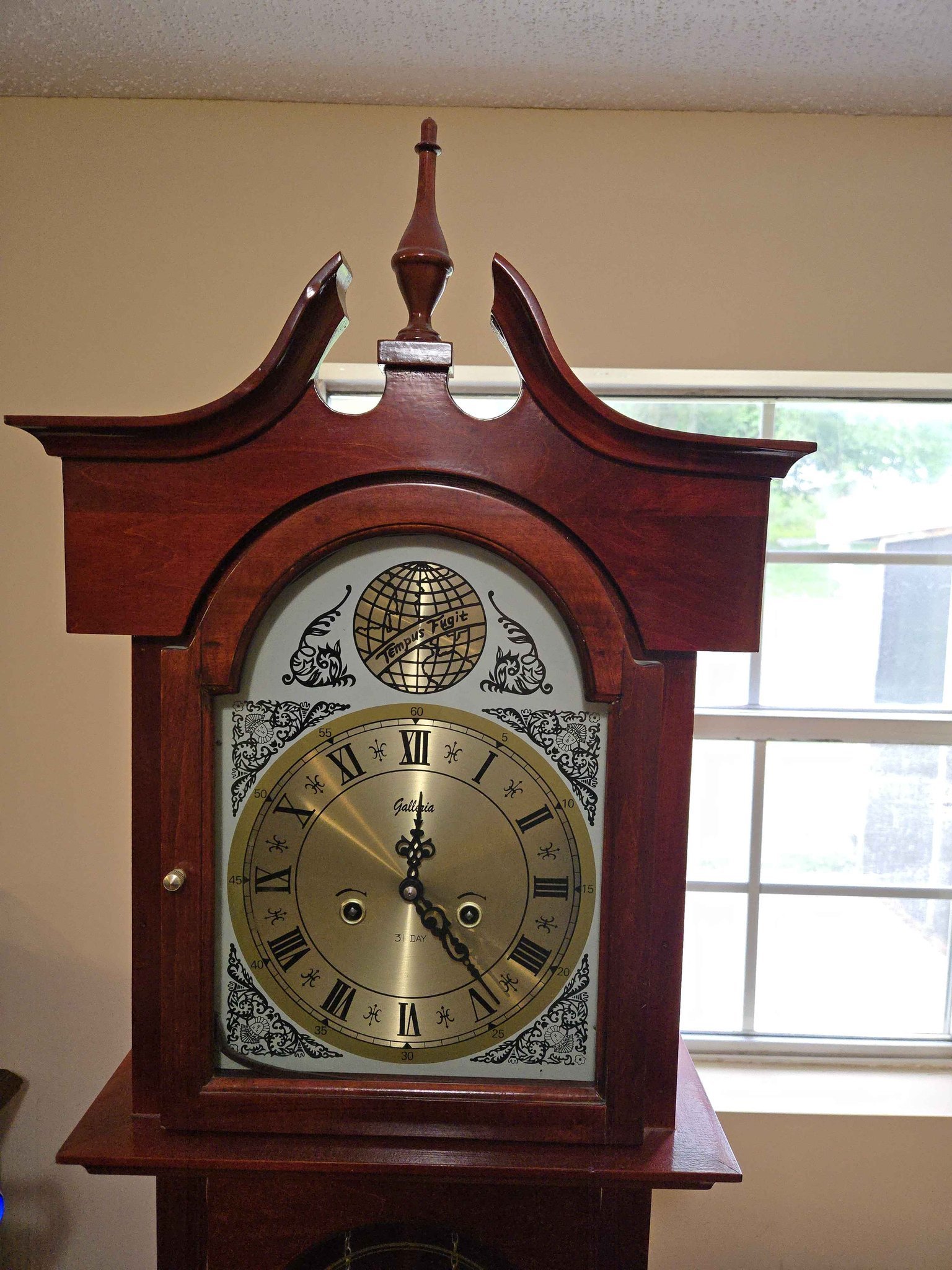Cherry wood grandfather clock has Galleria brand face with Tempus