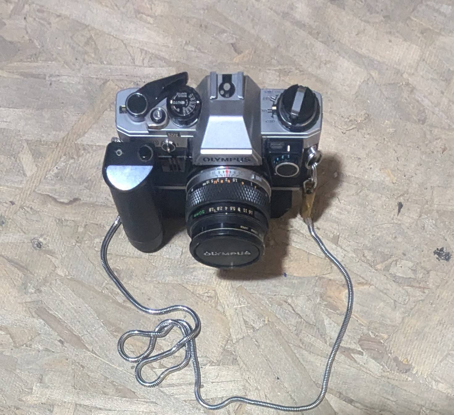 What accessories come with Olympus OM-10 and uses for old camera cases