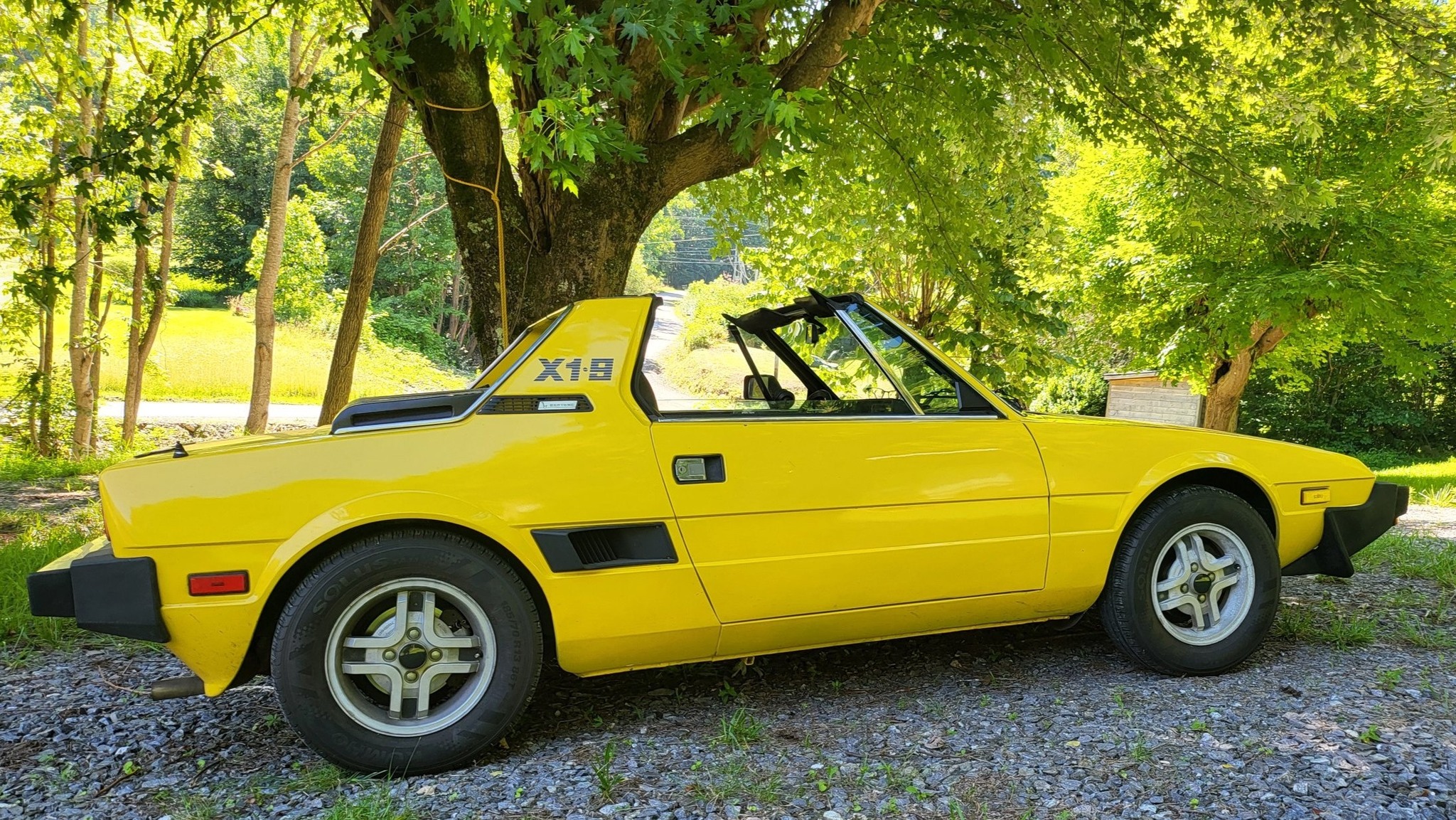 Restored yellow Fiat X1/9 perfect for mountain roads