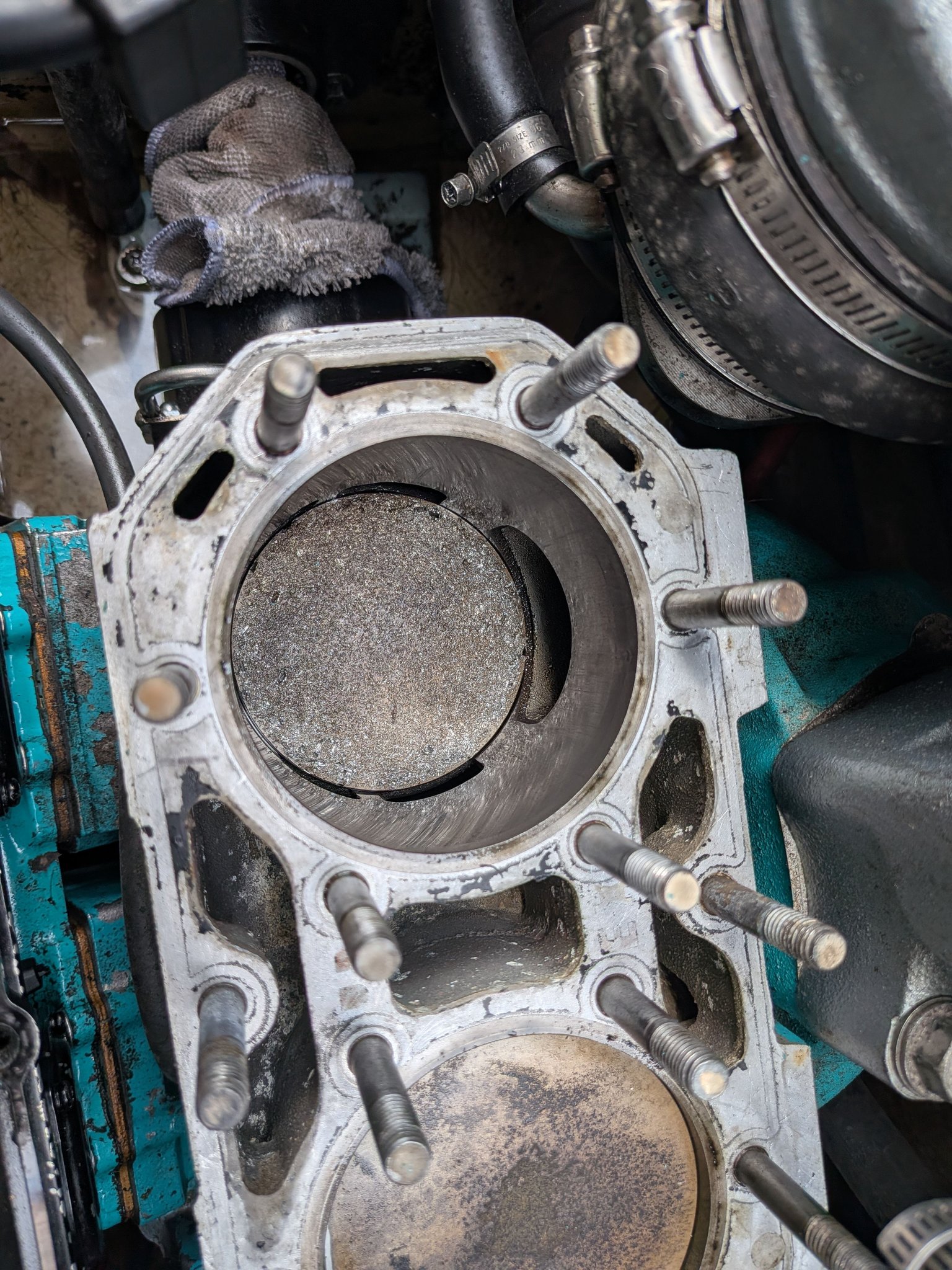 What causes piston damage in Kawasaki STS750 engines?