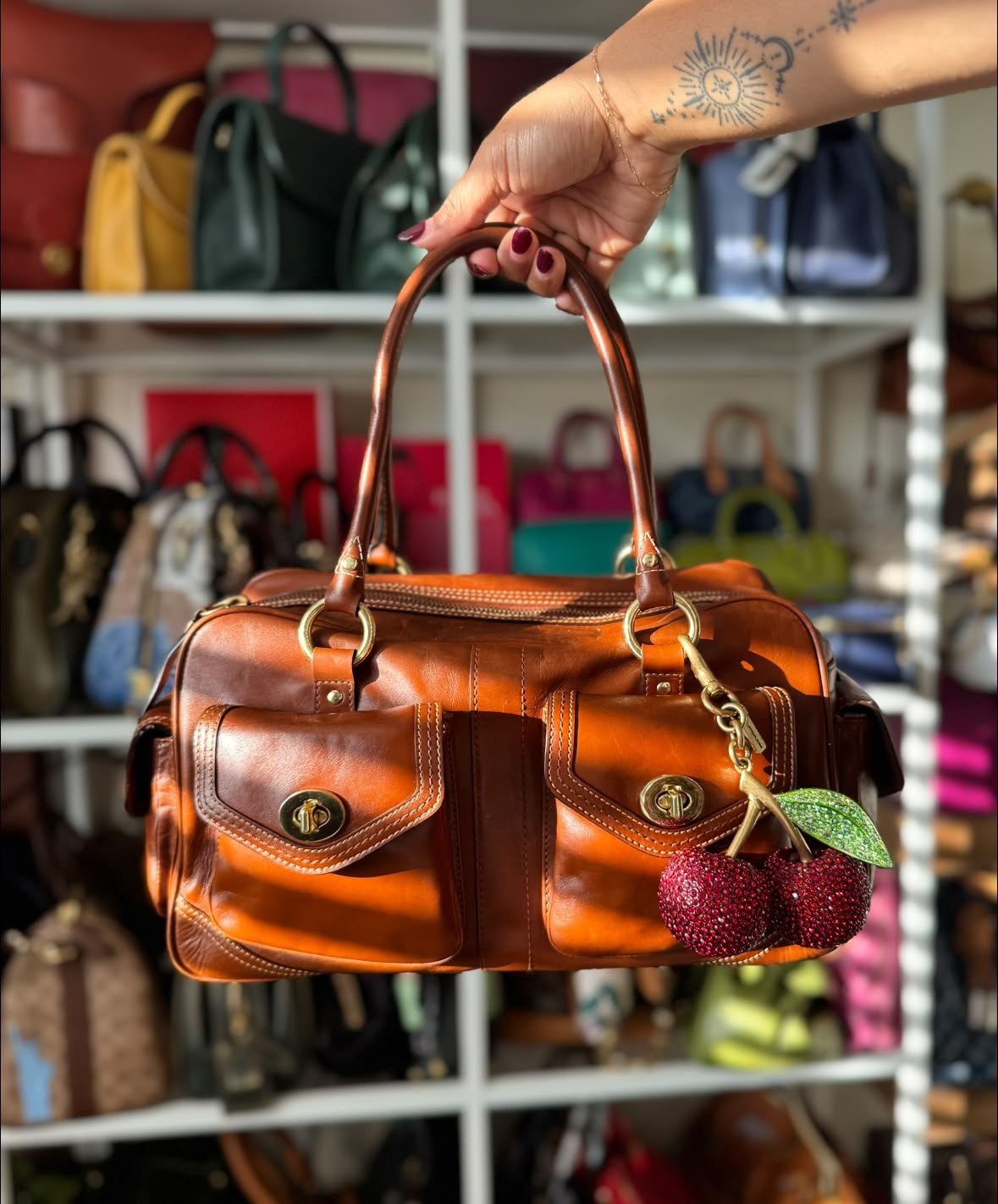 A playful expression of craftsmanship, the Coach Cherry Heritage
