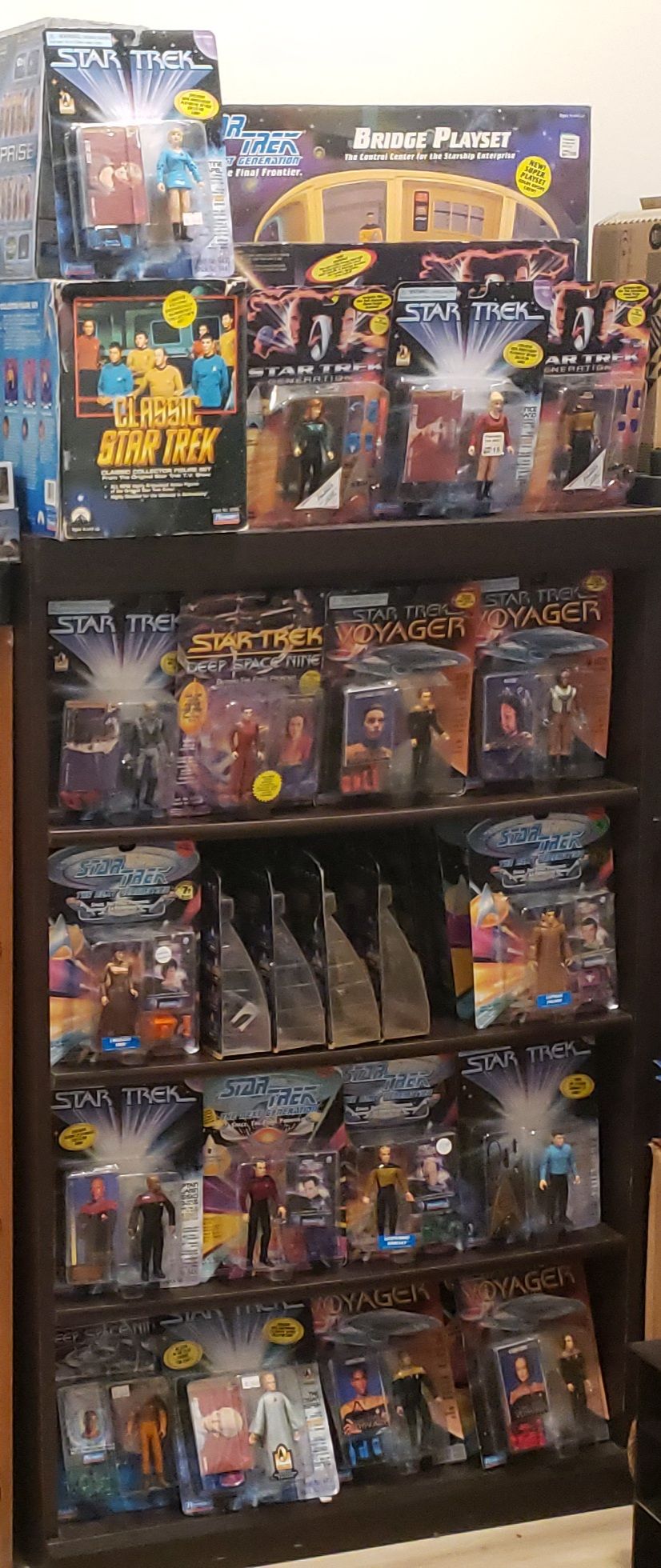 Star Trek figure collection in a larger shelving unit