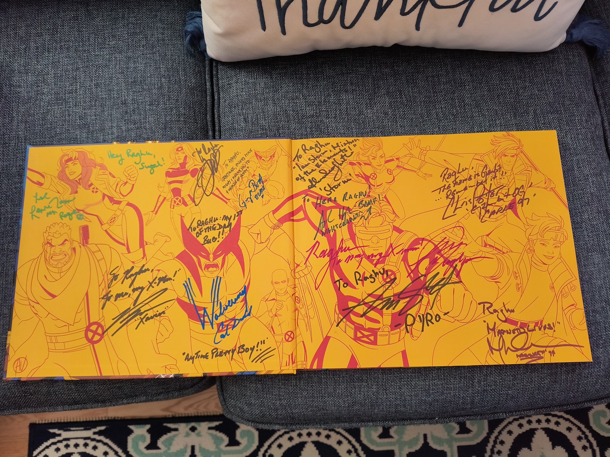 The cast of X-Men: TAS/X-Men 97 signing my Art of X-Men 97 during