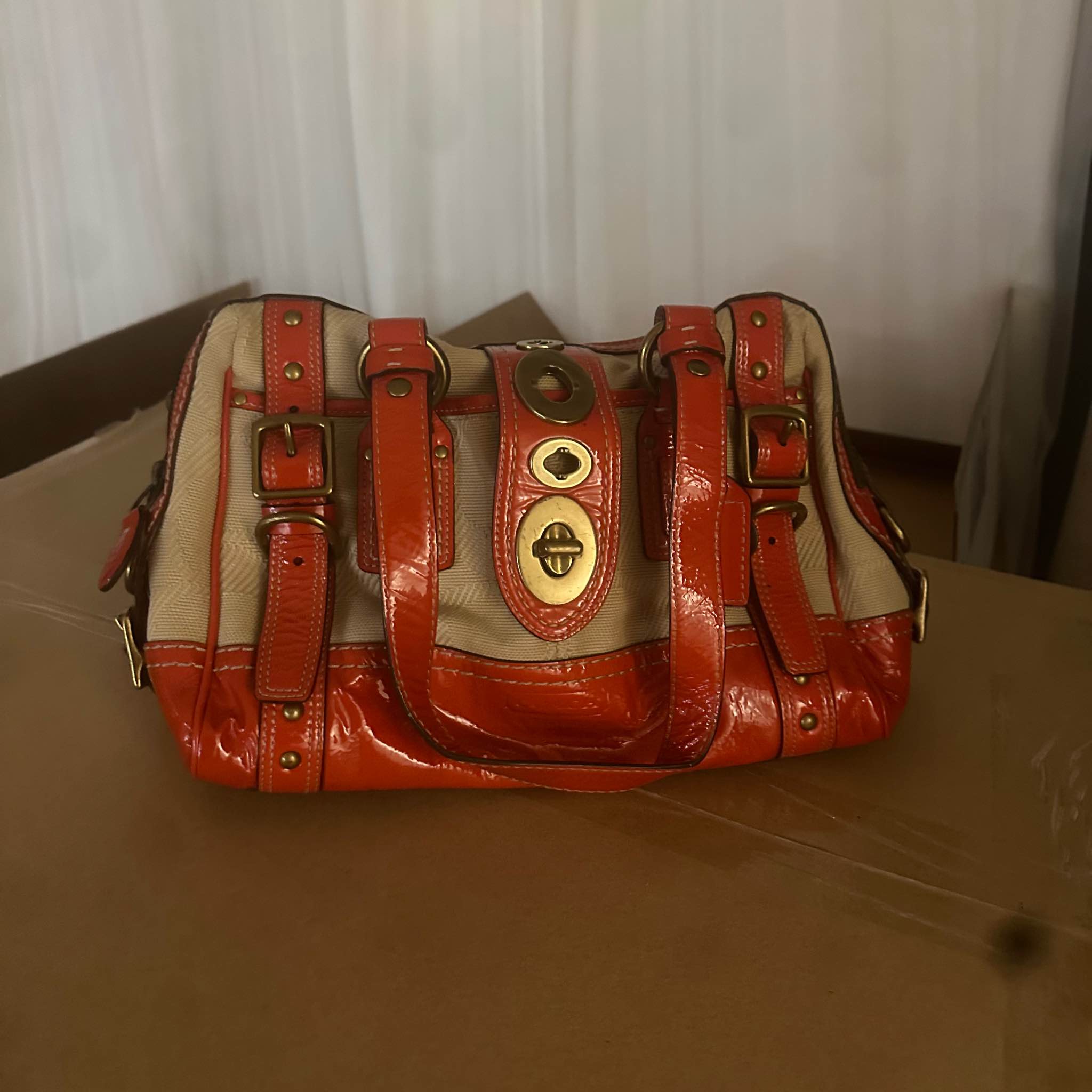 This is a Coach Legacy Lily Satchel in burnt orange patent leather 