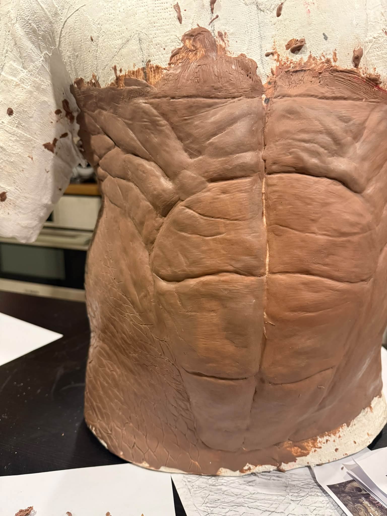 Sculpting a torso with detailed abs and ribs from clay
