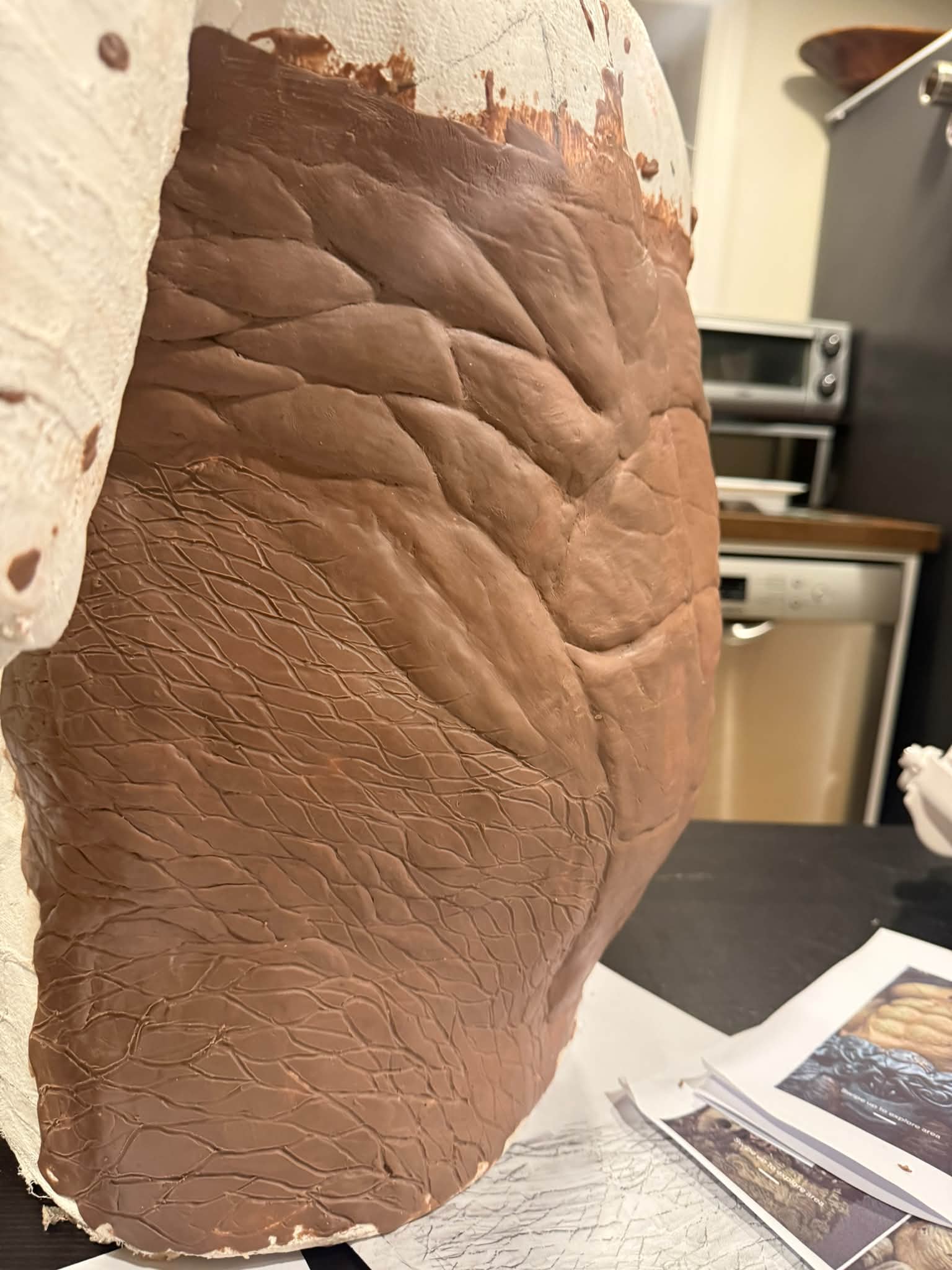 Sculpting a torso with detailed abs and ribs from clay