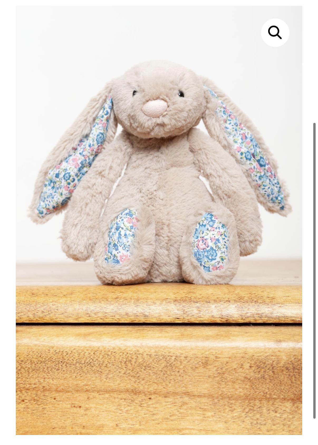 Small beige blossom bunny with blue floral ears?