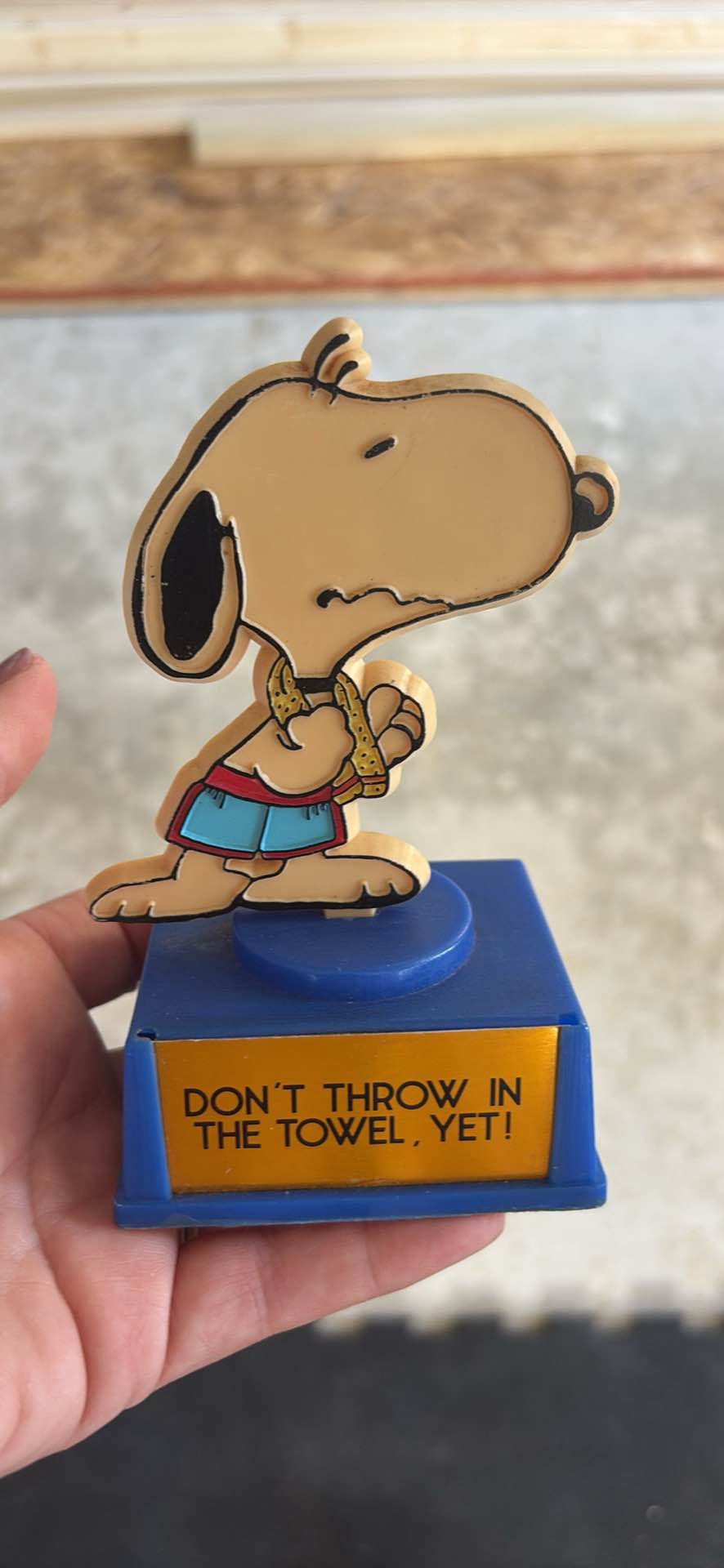 Vintage plastic Snoopy trophy has a blue base with a red felt