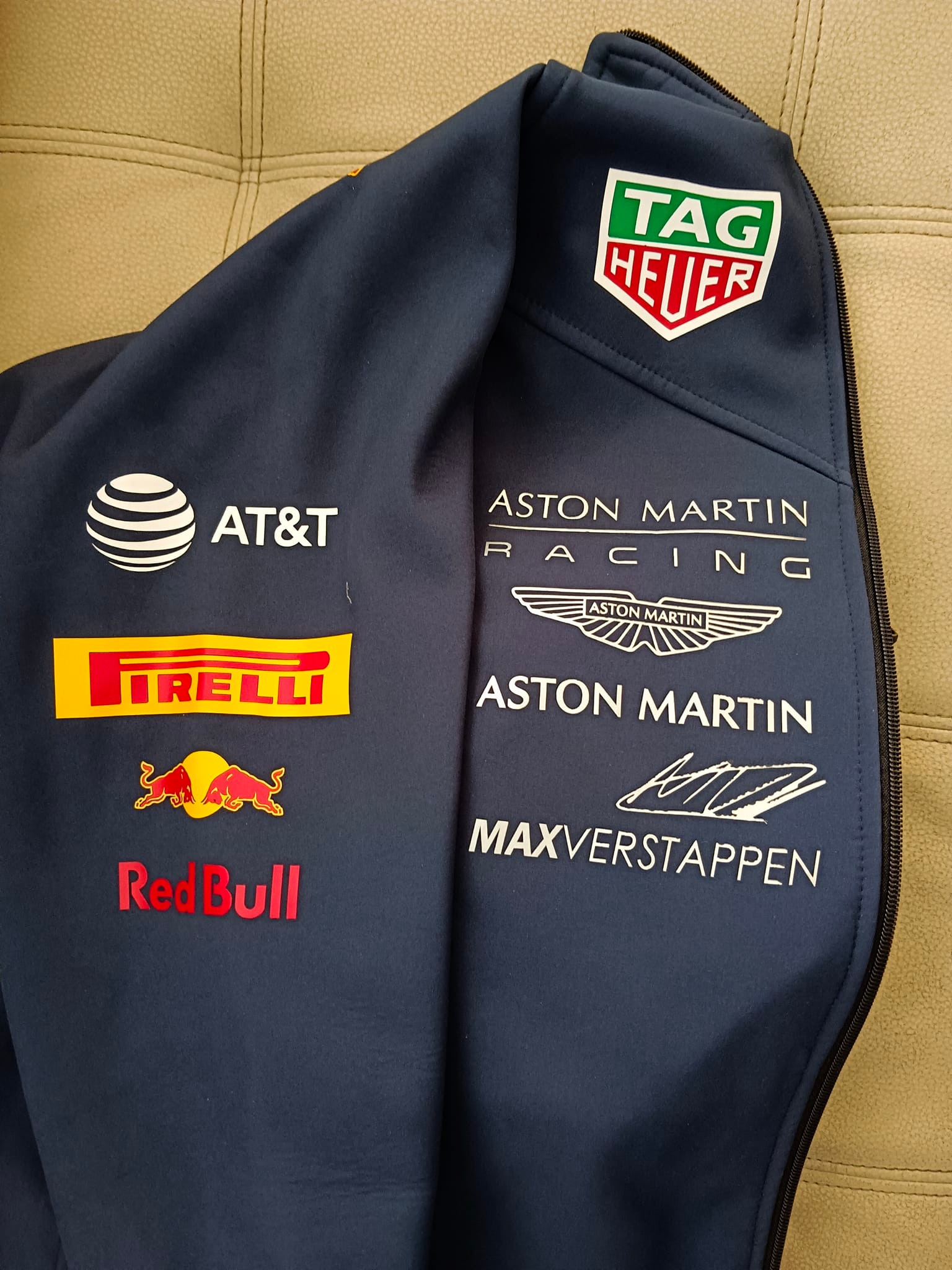 Why does Redbull jacket mention Aston Martin?