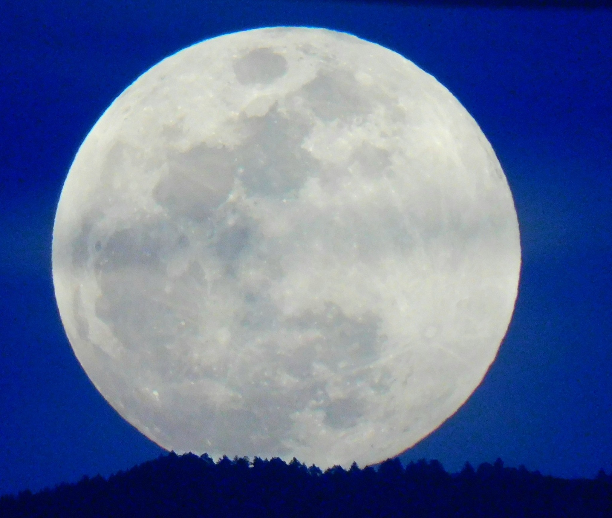 1st full moon of 2026 over the Sandia Peak, in clouds
