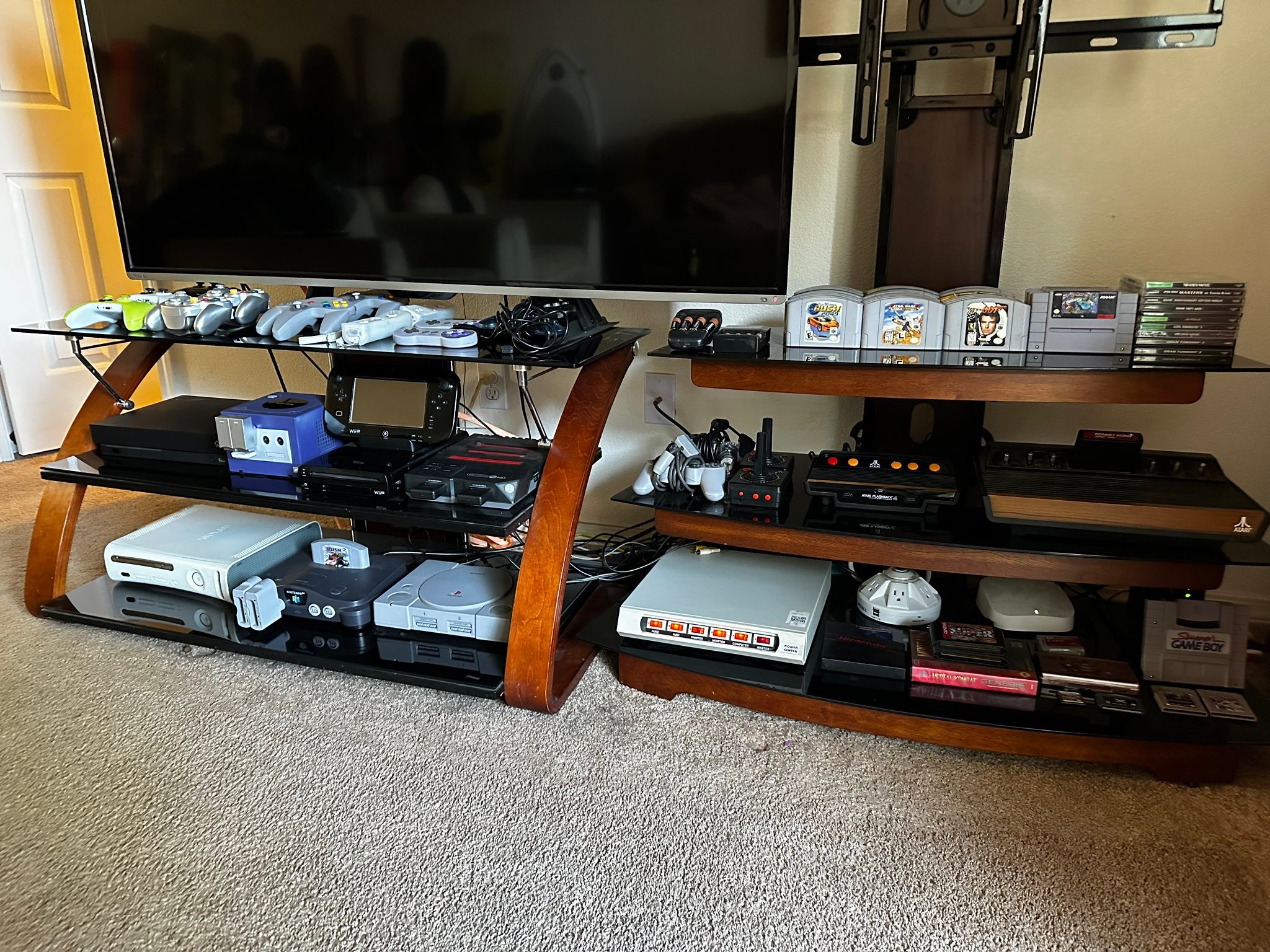 80s home entertainment setup with multiple consoles