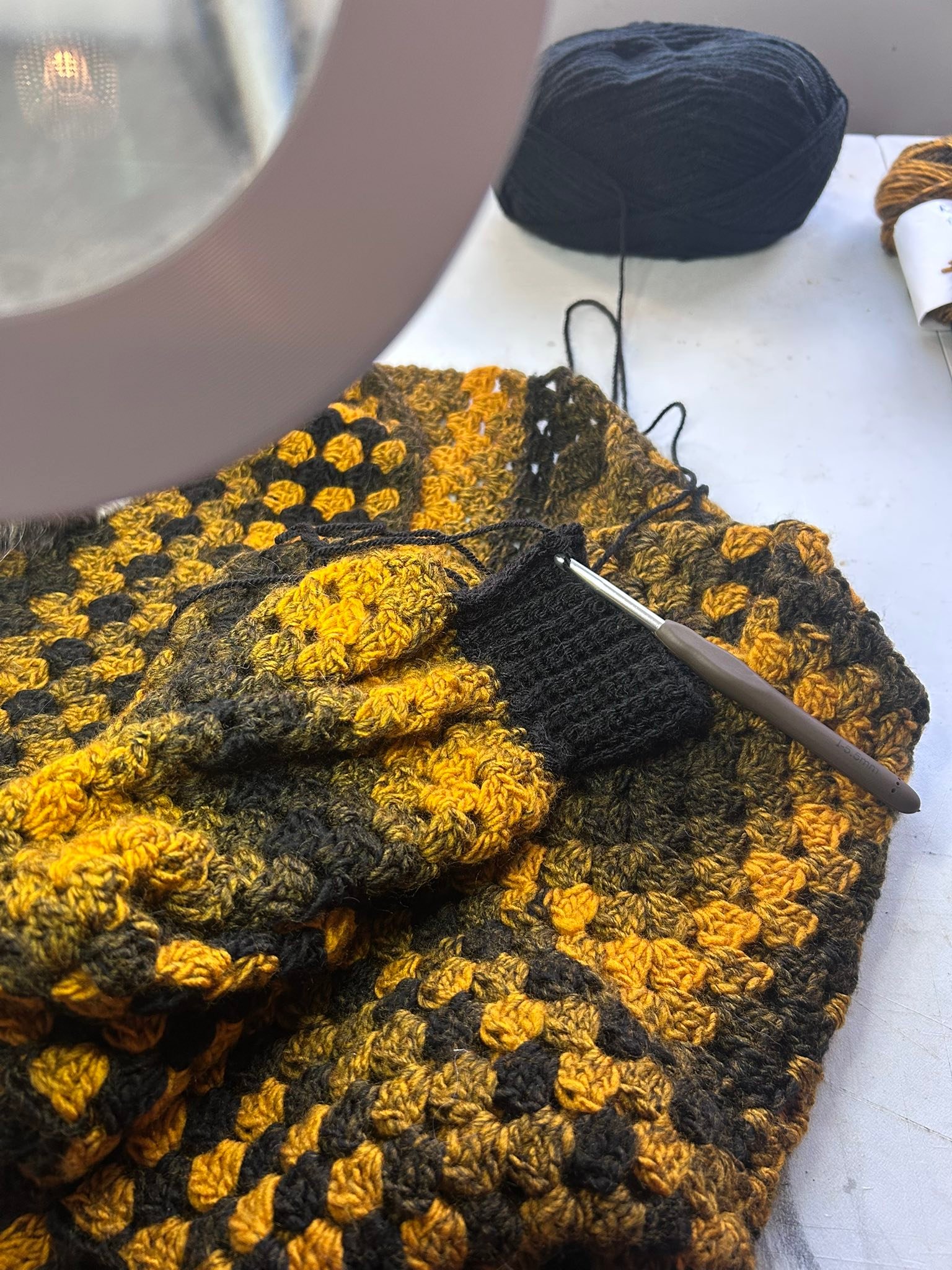 Crocheting a hex cardigan with black rib cuff