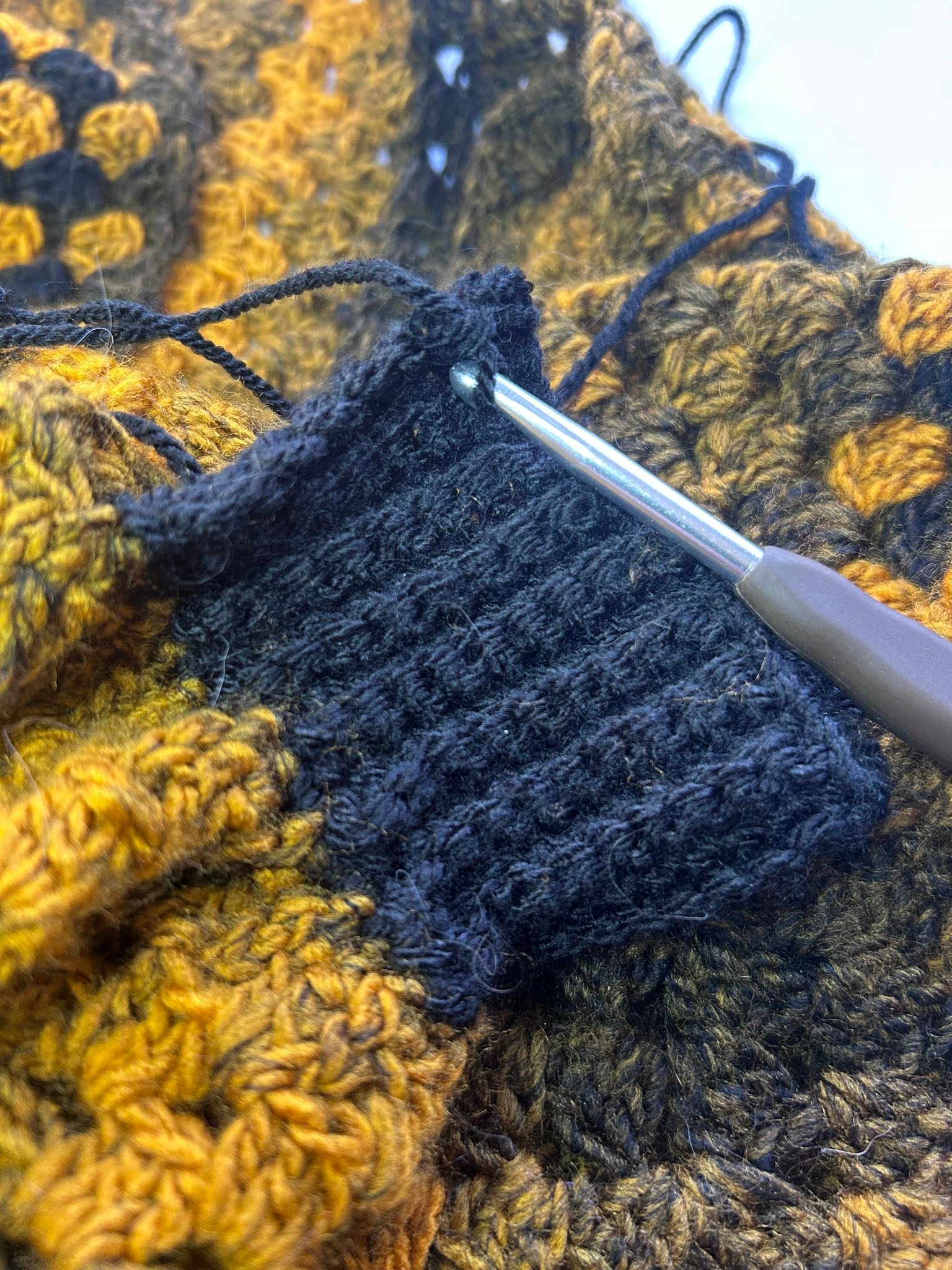 Crocheting a hex cardigan with black rib cuff