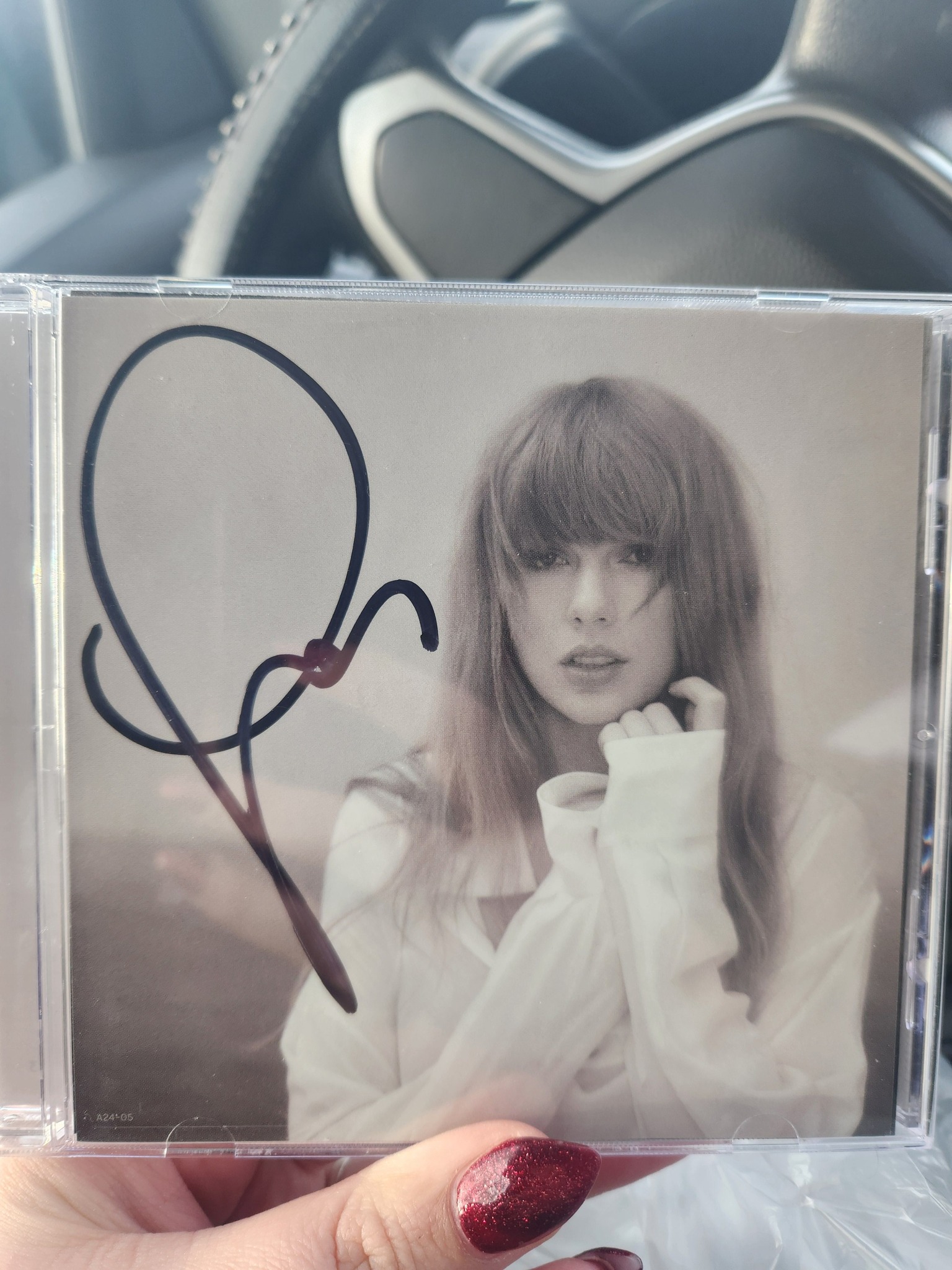 Taylor Swift fan collects signed TTPD cd with a heart