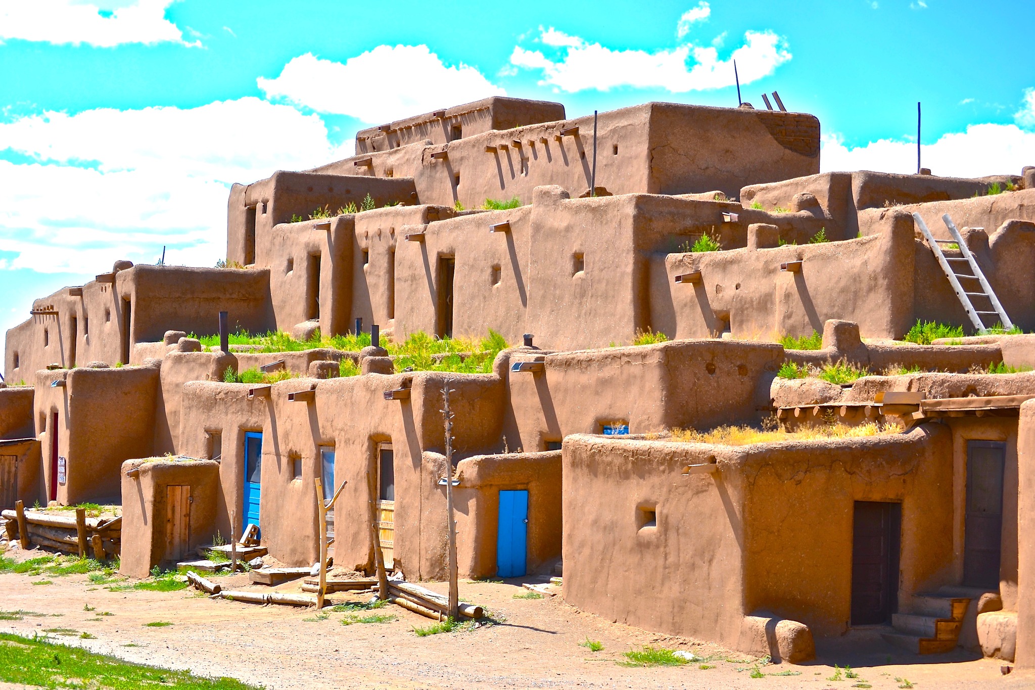 Taos Pueblo adobe dwellings with blue doors in New Mexico