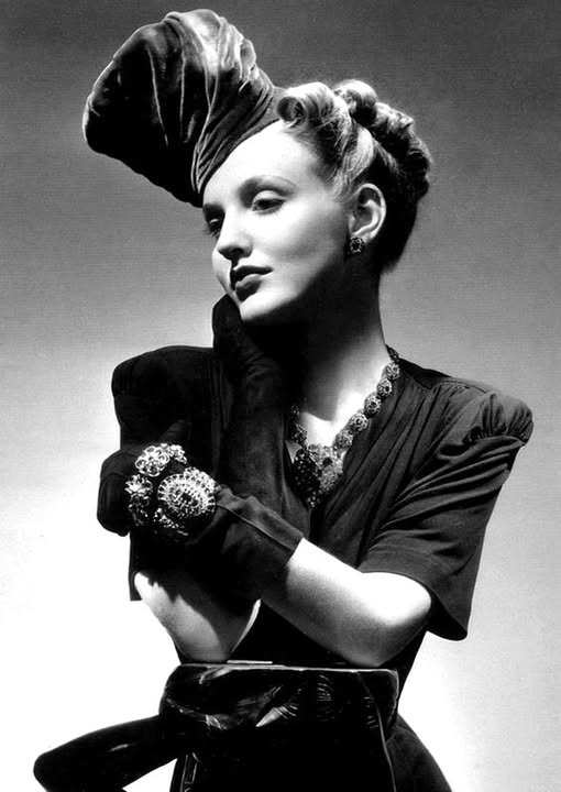 What are the details of the model's outfit in the 1938 Vogue magazine?