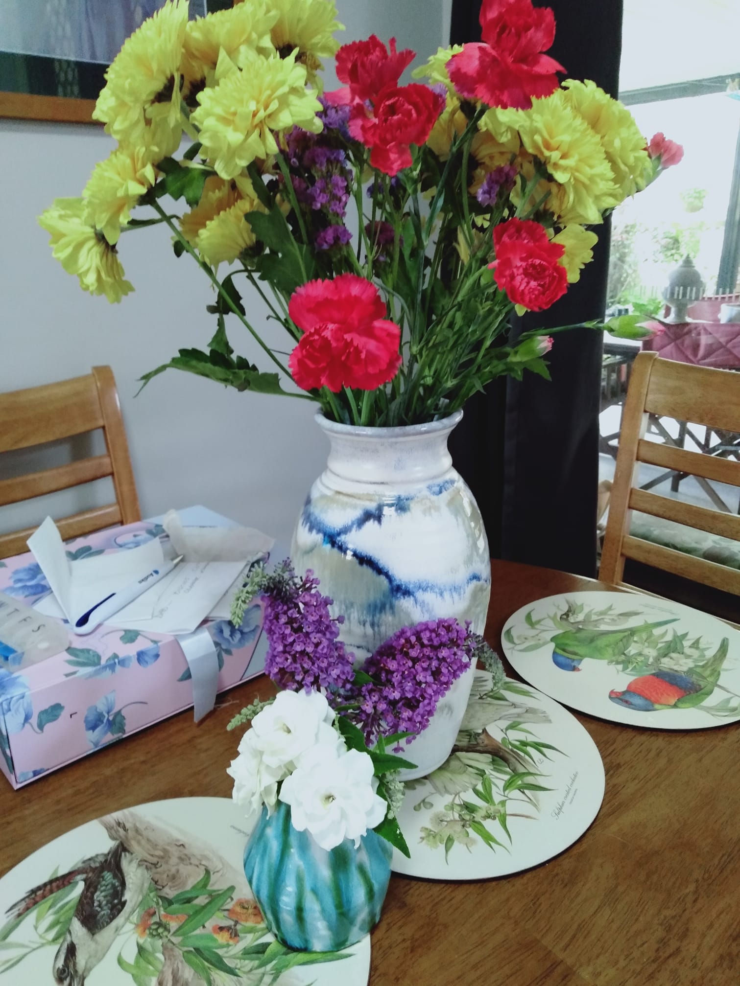 Vases with store-bought and homegrown flowers