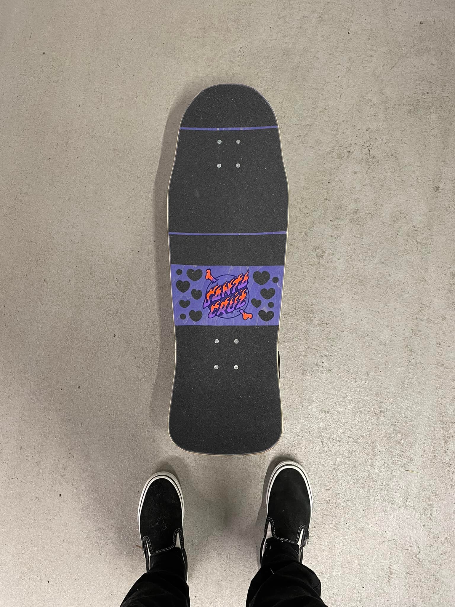 Riding a Santa Cruz Winkowski Volcano deck on a surfskate