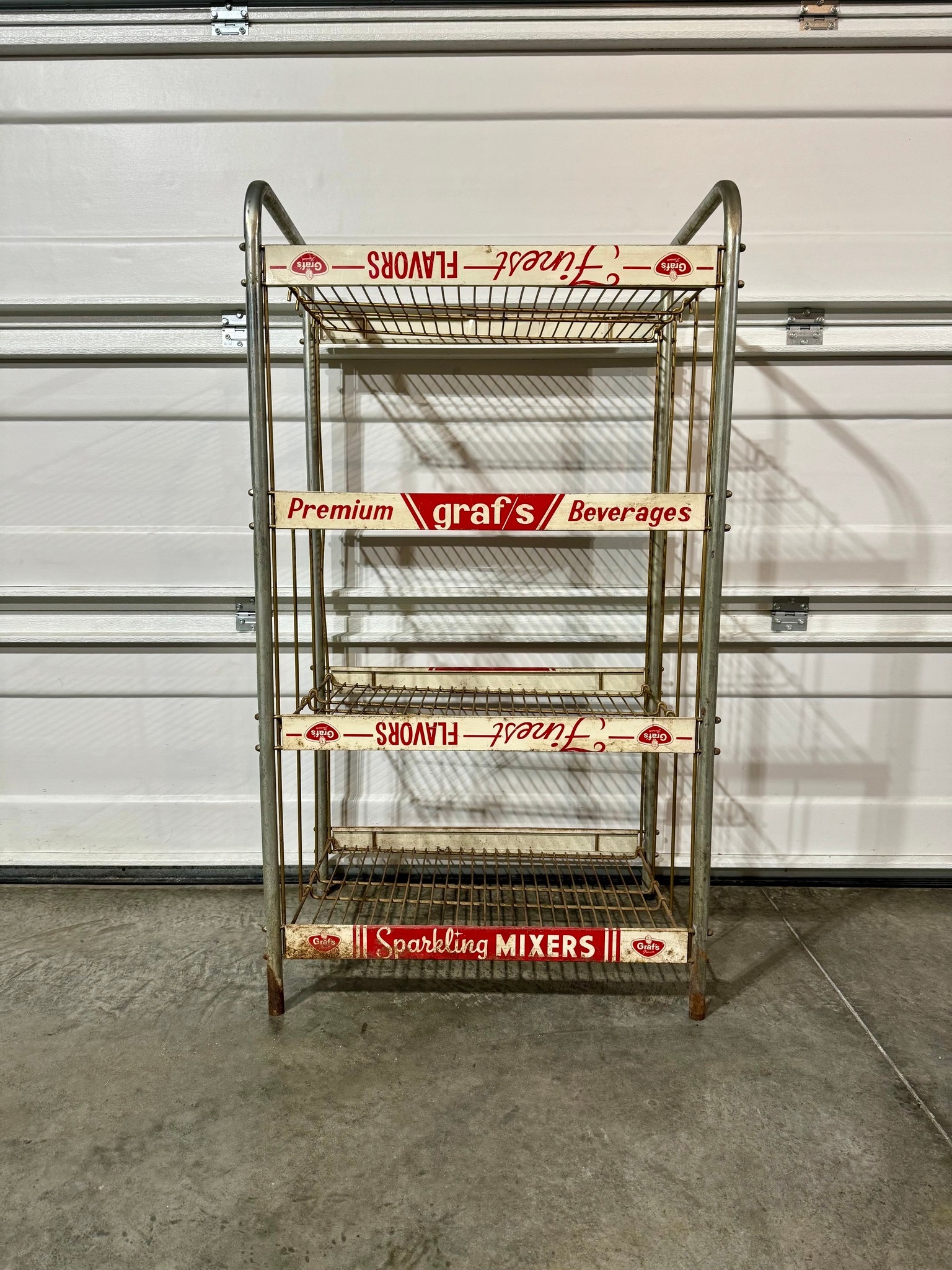 Vintage metal store display rack with header sign