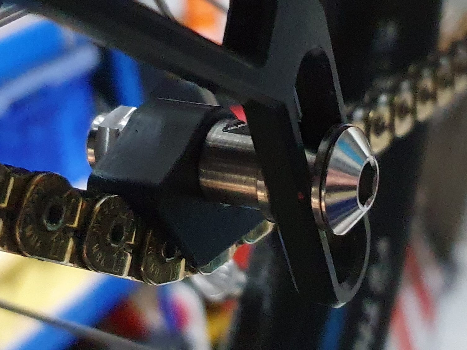 Custom made titanium hardware for the idler. Easy adjustment and
