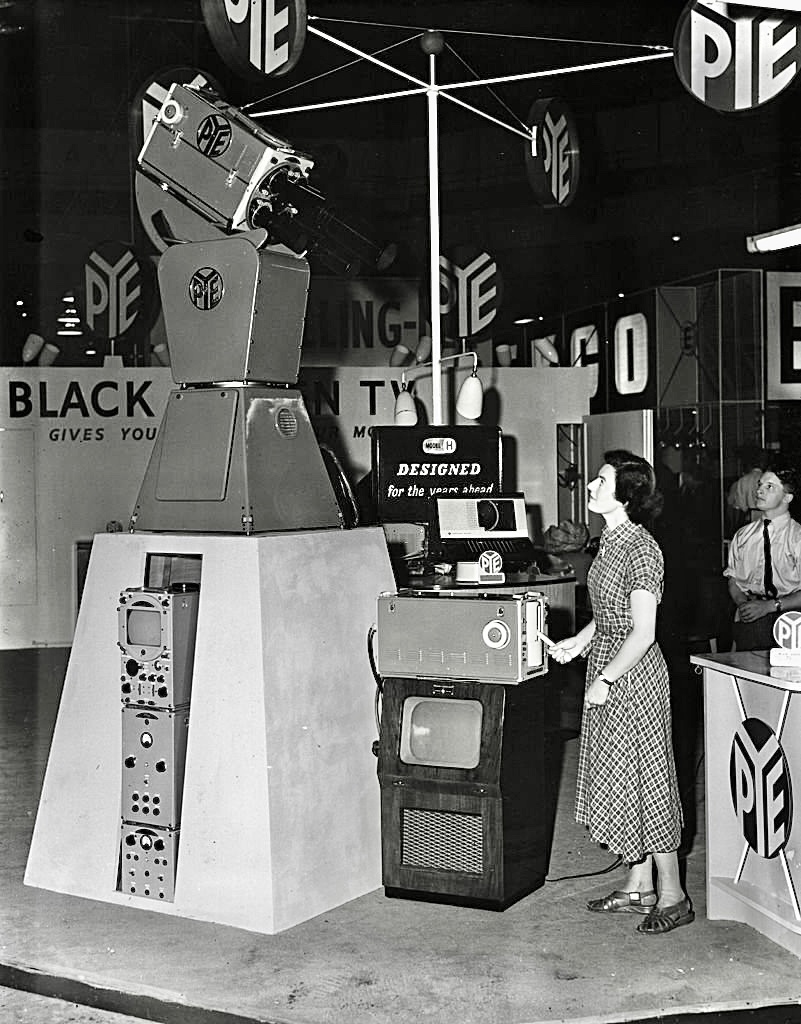 A woman using a portable micro television, invented by Sony in the